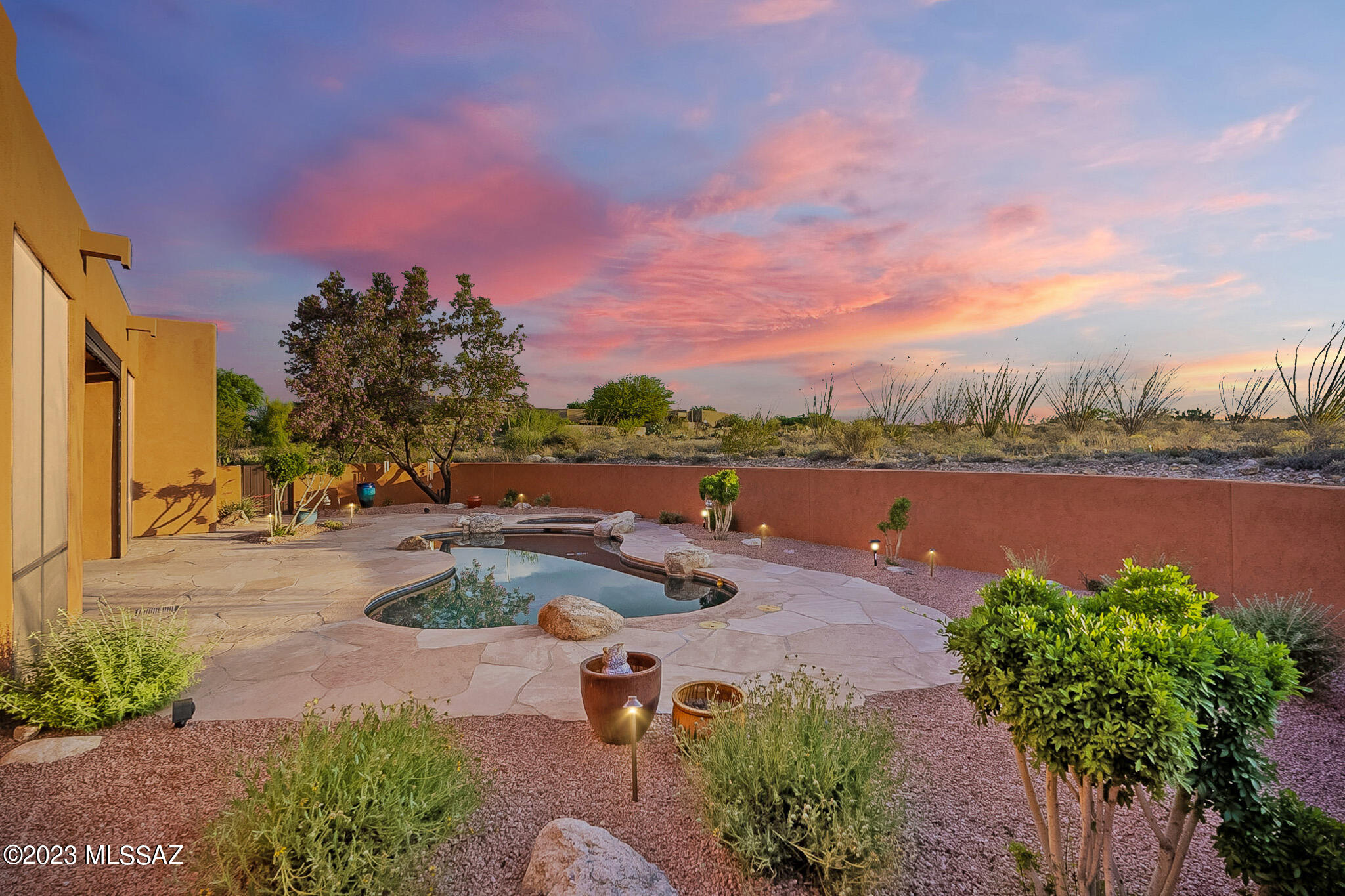 Don't miss the opportunity to own this magnificent Santa Fe-style home on over an acre with its spacious layout, luxurious amenities, and an incredible outdoor oasis. Experience the best of Arizona living in this captivating property. Located in the coveted school district of Vail, AZ. Enjoy the peace and privacy of a spacious desert retreat, while being just a short distance away from shops, restaurants, and outdoor recreational opportunities. Upon entering, you'll be captivated by all the amazing features this home has to offer, you will immediately be greeted by an amazing atrium where you'll discover a built-in grill perfect for those who enjoy outdoor cooking! Also, a beautiful dining room where you have an amazing view of the Rincon mountains while enjoying your favorite meal. 

The primary suite is a true sanctuary. With its spacious layout, private access to the outdoor oasis, it is the epitome of comfort and relaxation. The primary bathroom features a luxurious jetted tub, a walk-in shower, and dual vanities, with a huge walk-in closet. Three additional bedrooms provide ample space for family, guests each featuring ample closet space and large windows. Two of the bedrooms are accompanied by a Jack& Jill bathroom. The bathrooms are all tastefully designed, featuring modern fixtures and finishes. This home is also adorned with 4 bonus rooms such as an office with a murphy bed/desk which will convey, office adjoined with the master suite, a 9x9 storage room, and an awesome hobby room in the garage. 

The kitchen combines functionality and aesthetics seamlessly. The combination of tan granite countertops, stainless steel appliances, a dishwasher, trash compactor, double oven, gas cooktop with a vent, center island, and plenty of cabinet space creates a culinary haven that will inspire and delight anyone with a passion for cooking and don't forget about the massive walk-in pantry. The spacious living areas feature an open floor plan, perfect for both entertaining guests and enjoying quality family time. The living room is adorned with a grand fireplace, providing a cozy atmosphere. Large windows allow natural light to flood the space, illuminating the beautiful tile floors and showcasing the breathtaking views of the desert oasis. 

This backyard provides an idyllic setting to enjoy the stunning outdoor beauty that the area has to offer. With an 8-foot-deep pool, beautiful landscaping, flagstone patios, rolling screens to enclose the patio, security doors, and ample space, this outdoor paradise awaits your personal touch. Embrace the Arizona lifestyle and create lasting memories in this extraordinary backyard oasis. The 3-car extended garage provides an exceptional space that exceeds expectations. From the custom enforced garage doors to the epoxy floors, storage cabinets, central vacuum system, and dedicated hobby room, every detail is carefully considered to enhance your garage experience. Embrace the possibilities and make this home your personal sanctuary.