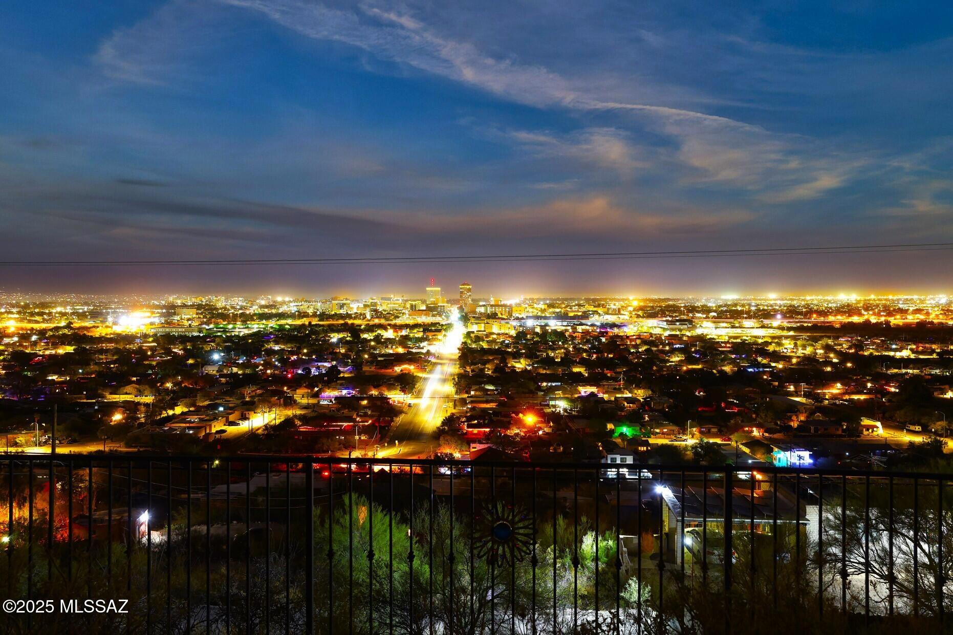 Breathtaking city lights & majestic mountain views offer an irreplicable panoramic experience whilst nestled in a saguaro-studded hillside.  The open layout  & expansive windows ensure that postcard-worthy views are an integral part of your living space w/a backdrop evolving from day to night.  Kitchen has gorgeous wood cab, lg island and of course, those big views. Spacious grtrm offers a contemp FP.  Generous primary suite has a sitting area, soaking tub & walk-in shower. Live an unparalleled Tucson lifestyle in the heart of downtown w/a vibrant cultural scene, eclectic restaurants, galleries, theaters, shops and events just outside your door. Hike Tumamoc, enjoy the A Mtn fireworks from your lg cov'd patio or unwind in the hot tub as the lights come up. Welcome to your new urban oasis.