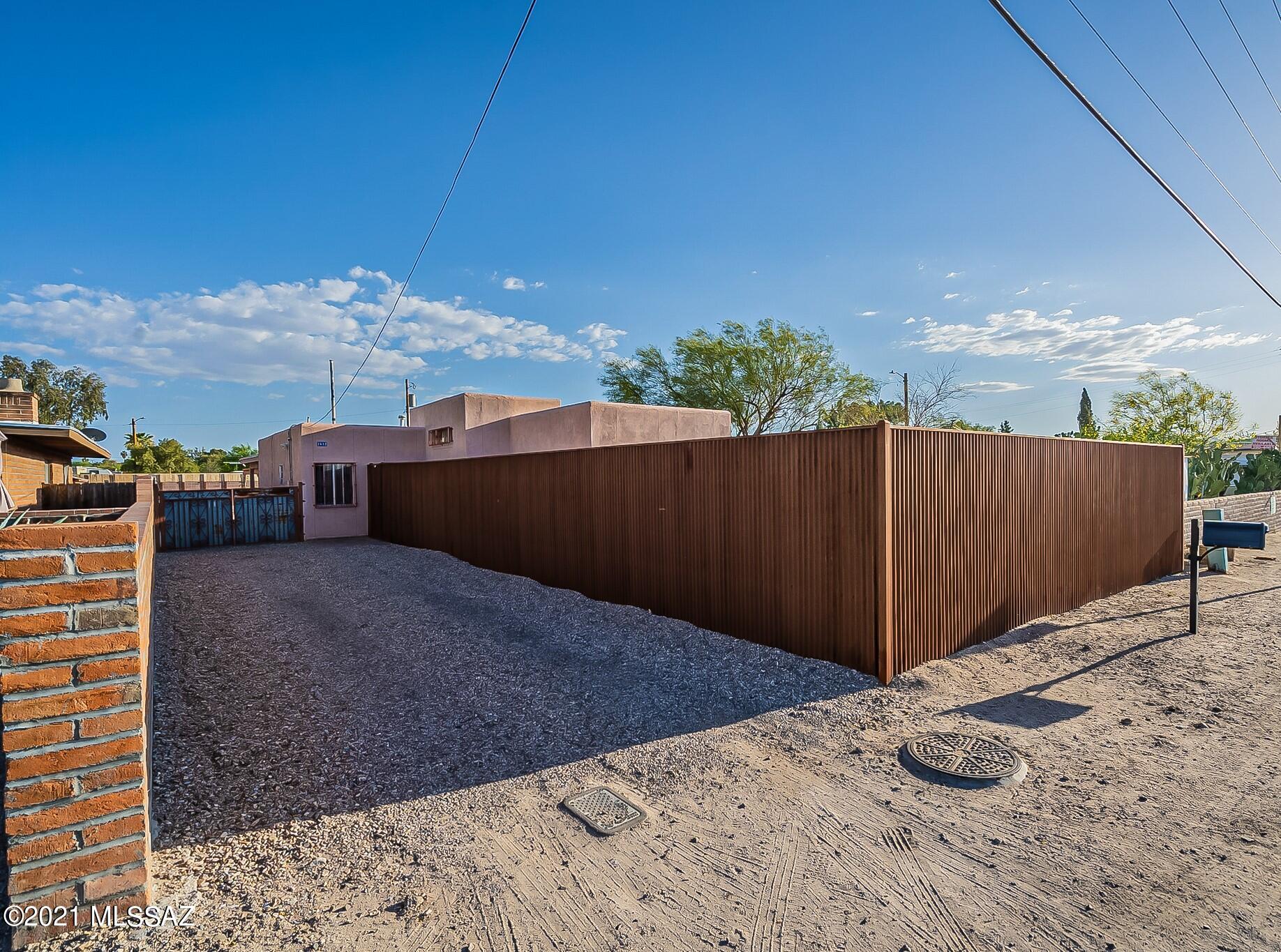 Charming home in Central Tucson with pastoral and mountain views! Sitting on a .22 acre lot, overlooking the University of Arizona Agricultural Center, conveniently located near shopping and dining. Minutes away from the Mountain Ave bike path and the Rillito River. Lovely and move-in ready with updated touches. Large yard with covered patio, Ramada, built-in firepit and siting area is perfect for entertaining and still leaving plenty of room for RV parking and/or to build your own pool. NO HOA! Appliances and two large storage sheds convey with sale. Don't miss out on this gem, schedule your showing today!