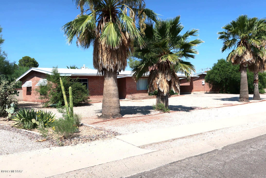 Nice remodeled Brick Home 3 Bedroom 2.5 Bath located in Central Tucson, Convenient to Shopping and U of A. AC and Tile flooring throughout. Formal Living room and Formal Dining Room with built-in Cabinet and Fireplace. Open Kitchen with plenty Cabinets and large breakfast area. Low care landscaping with covered Patio and dog run. Washer and Dryer hookup, storage, one car carport. All Pets must be Preapproved with Fee.