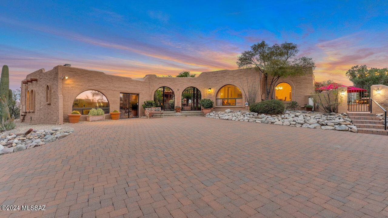 Stunning mountain views from this 2016 remodeled hilltop home. Island kitchen boasts hand painted Tabarka tile backsplash, induction cooktop, Bosch appliances, pot filler, soft close cabinets, pull-outs, and a coffee bar/nook. BBQ area off the kitchen. Spacious family rm w/stone fireplace & wet bar.  AZ rm w/Pella windows & doors. Primary bdrm features an elegant bath, dust free closet, beehive fireplace. Separate office/media rm includes theatre seats, power shades, wet bar, & half bath. Private entry guest qtrs w/Jack and Jill bath, & kitchenette.  Flex room:  exercise or crafts, not in sq ft. Enjoy sunsets & city lights from the play pool or spiral staircase to a rooftop deck. Winding Belgard paver driveway to a 2-car garage and workshop + 2-car tandem easily converted to an RV garage. soaking tub, glass shower and dual marble vanities. Spend movie nights in a separate office/media room with comfy theatre seats, power shades, a wet bar, a cozy wood stove and a powder room. There is even a private entry one or two bedroom guest house with its own kitchenette. Relax poolside to enjoy the Arizona sunsets and city lights or take the spiral staircase for a better view from the rooftop deck. The Belgard paver driveway winds up to a two-car garage and workshop plus a two-car tandem that can easily be converted to an RV garage. Appreciate the well-maintained, low care desert landscaping.