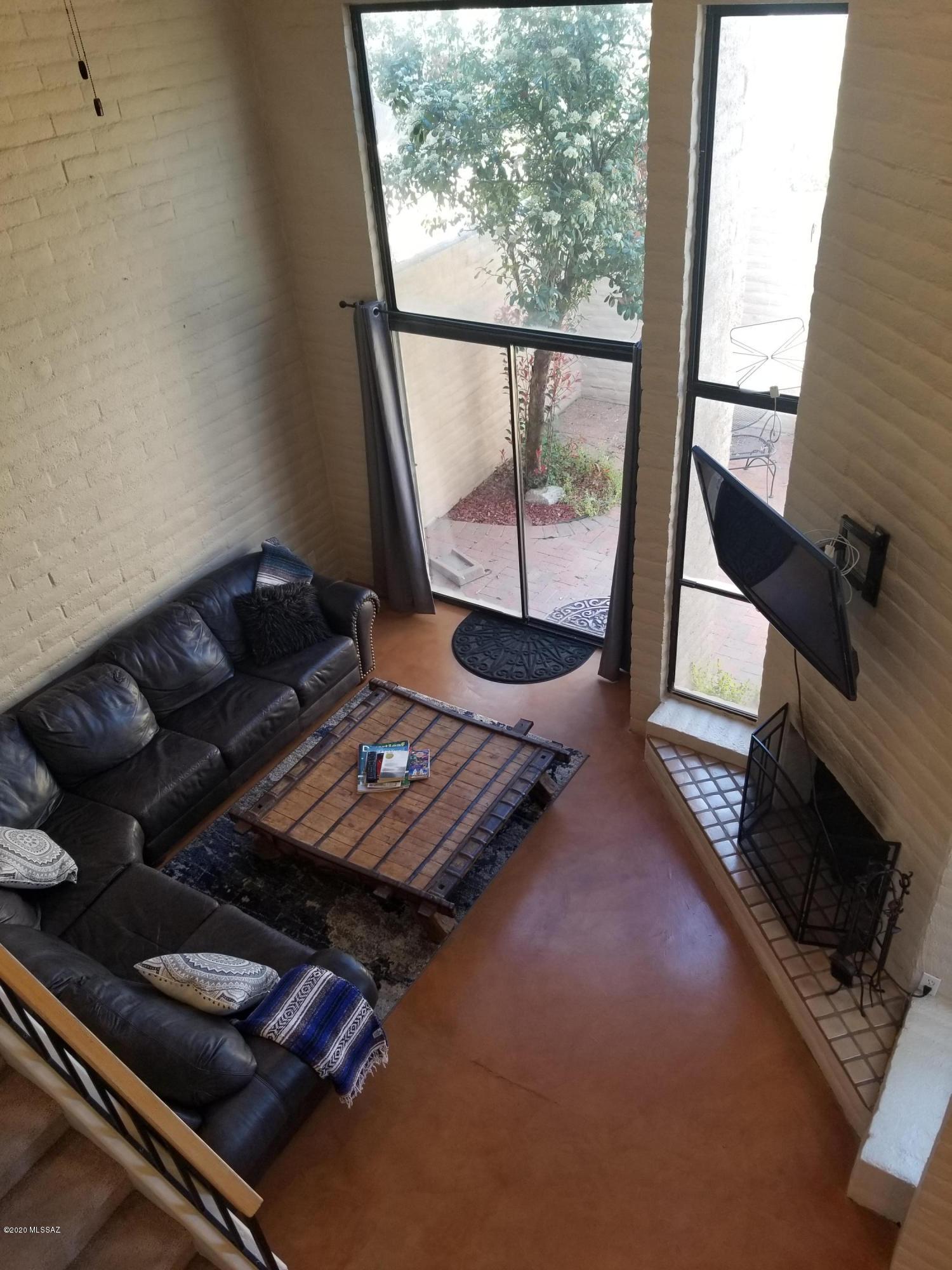 Come see this charming townhome quietly tucked away in well-established Tamarisk Community.  Great Central location close to Tucson Racquet Club, St. Phillips Plaza, & Rillito River Walk.  Private, gated courtyard entry.  2 story townhome features high ceilings, spacious living area, classy staircase, massive windows, fireplace, & adorable backyard.  1 bedroom & bathroom downstairs, 2 bedrooms & bathroom upstairs allows for plenty of space & privacy.  Open kitchen features upgraded appliances & cabinets.  All wood interior doors & casings are an added touch.  Big pantry & loads of closet space. 
Beautiful community feeling with mature landscaping abound.  Heated pool & spa. All appliances stay.  HOA covers water, sewer, garbage, street & landscape maintenance.  Call to see it today!
