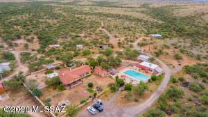 This is it! Your very own oasis in the desert.  A one-of-a kind, private compound set on 80 acres of pure serenity known as 'Desert Sanctuary Ranch'.  This amazing property boasts over 6800 sqft and a total of 11 structures that include: a main residence (2216 sqft 3br/3ba), 4 guest cottages, dining hall, prayer house, pool house, vintage farmhouse and various storage structures. Upon arrival through the private gate, you're welcomed by a wrought iron entry to the lovely front courtyard of the main residence. An oversized covered front porch brings to mind warm sunny days sitting on a rocking chair with an ice cold glass of lemonade. Relaxing and taking in the quiet desert beauty and endless mountain views that surround you.  The main home has been renovated with warm wood look floors throughout, charming tile detail around the cozy fireplace and relaxed rustic feel throughout. Enjoy all the modern day comforts in the renovated kitchen and baths while blending with the original essence of the home. 

The kitchen has been updated with warm oak cabinetry, granite countertops w/ center island & stainless steel appliances and at the heart is the vintage fire stove.  

Master bedroom is complete with separate sitting/office area and spacious custom closet. 

Four guest cottages (Doll House, Saguaro House, Zitko House & the Round House) each have a completely different look and are full their own unique personality! Guest cottages are currently used as Airbnb. 

Shared spaces include: a newly re-plastered olympic size swimming pool with a large pool house/game room, outdoor restrooms/showers, huge dining hall for private parties and events, custom designed koi pond and multiple RV, dry camping & picnic sites throughout the property. 

Desert Sanctuary Ranch is a unique opportunity to own an amazing property rich in history. From the time is was originally homesteaded by the first Sheriff of Pima County in 1800's & served as a cattle ranch, through it's use in the 1960's as a spiritual retreat and pottery/artist commune by well-known psychologist Timothy Leary, to the headquarters for the World University in the 1970's.  Desert Sanctuary Ranch has now been lovingly restored and is unlike anything else you'll see. (see documents tab for more details on property history, structures and improvements)

Come tour this hidden desert gem and envision the endless opportunities!