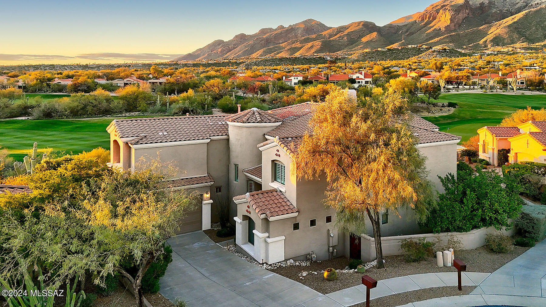 Welcome to your dream home in coveted La Paloma, crafted by renowned AF Sterling. Nestled at the end of a tranquil cul-de-sac, this exquisite residence boasts unparalleled quality construction and a spacious floor plan that invites comfort and luxury living. Perched elegantly on a premier golf course, prepare to be mesmerized by the breathtaking panoramic views of the majestic mountains that serve as your backdrop. This two-story masterpiece features 5 bedrooms, offering ample space for relaxation and rejuvenation. Additionally, indulge in entertainment and leisure in the dedicated media room, perfect for movie nights and gathering with loved ones. The heart of this home lies in its gourmet kitchen, replete with countless cabinets, a sprawling island, casual dining space, & a walk-in pantry. Adorned with custom backsplash and granite countertops, this culinary haven opens seamlessly to the inviting family room, where a cozy fireplace beckons on chilly evenings. Upon entry, be greeted by a grand dining/living area boasting soaring ceilings and walls of windows, infusing the space with natural light and a sense of openness. Revel in the elegance of hardwood floors adorning the stairs and breezeway, complemented by the timeless allure of slate and plush carpeting throughout. Experience indoor-outdoor living at its finest as you step onto the patio, complete with a fire pit, where you can unwind and savor the mesmerizing vistas that stretch before you. This meticulously maintained home is equipped with modern amenities, including newer HVAC and a brand new water softener, ensuring comfort and convenience year-round. Other notable features include a central vacuum system and alder doors throughout, adding both style and functionally to this exceptional home. Make this slice of paradise yours, and discover the epitome of luxurious living in La Paloma.