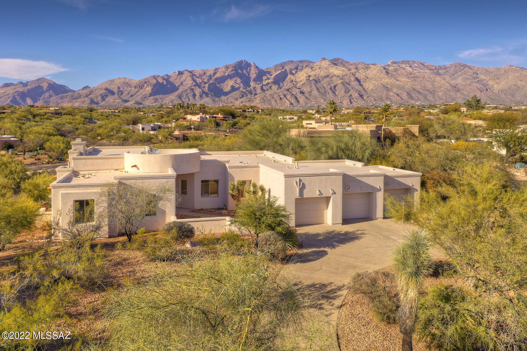 Great curb appeal. MTN views. Immaculately maintained. 4Bdr+office, 3ba, SW soft contemporary. Expansive great room  has wall of windows and unobstructed  MTN views. High ceilings & fireplace in wall of niches. Spacious kitchen w/granite counters, roll-out shelves, SS appliances, gas cooktop, Primary bdr wing includes 2nd bdr, and office w/ double Alder Door entry for additional privacy. Split Bdr plan with 2 guest bdrs on opposite wing. Formal Dining. Many etched glass windows, Rolling shutters on most windows. No steps.  All tile floors. Large rear paved patio overlooks common ground and mtn views beyond. Snake deterrent fencing. Spacious 3 bay garage w/abundant storage/addl storage rm and new insulated garage doors. Circular driveway, Close to JCC, UA, Banner & TMC Hospitals. Gated Comm