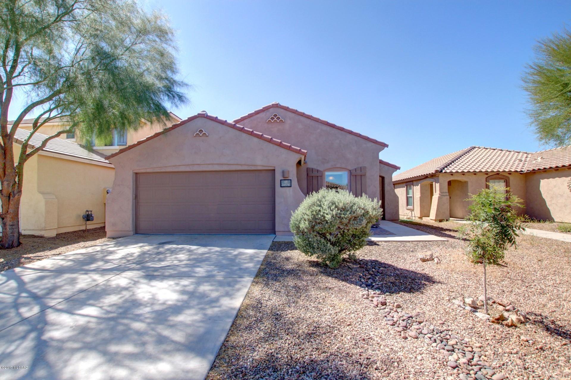 Don't miss this Lovely 4 bedroom/ 2 bath/ 2 car garage single story home in Rancho Sahuarita! Bright open floor plan with beautiful laminated wood flooring in living/dining area, tile flooring in all wet areas and carpet in bedrooms. Spacious kitchen with all appliances included and good size breakfast nook. Washer and Dryer included Enjoy the privacy of the landscaped backyard  with pavers, artificial grass and decorative rock. NO NEIGHBORS BEHIND. This property is in move in condition.