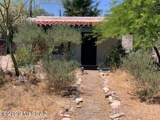 Property is ready for a handyman/investor. Needs roof work & HVAC replacement.Saltillo tile & colored concrete floors in 2 bdrm 1 bath main house. Guesthouse/Studio w 12' ceilings & concrete floor. Shady fenced yard w mature trees & patio. Convenient central location.Property AS IS no repairs to be done by Seller.
