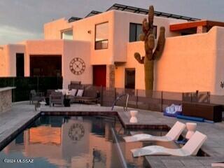 Panoramic views define the essence of this exceptional estate. Nestled on a 0.86-acre lot, this architectural marvel is crafted to maximize the breathtaking vistas of the Catalina Mountains to the North and the unique cityscape to the South. A custom-designed grand staircase welcome you to the entrance, where you'll immediately appreciate the stunning city views from the front courtyard. The real enchantment begins at night when the city lights create a mesmerizing spectacle. These spectacular views can also be enjoyed from the living room, dining room, and the aptly named City View Bedroom.
*The Solar is owned, new blinds installed, a whole house water filtration system was added, new paint on outside, New custom toilet added to guest bathroom and much much more!