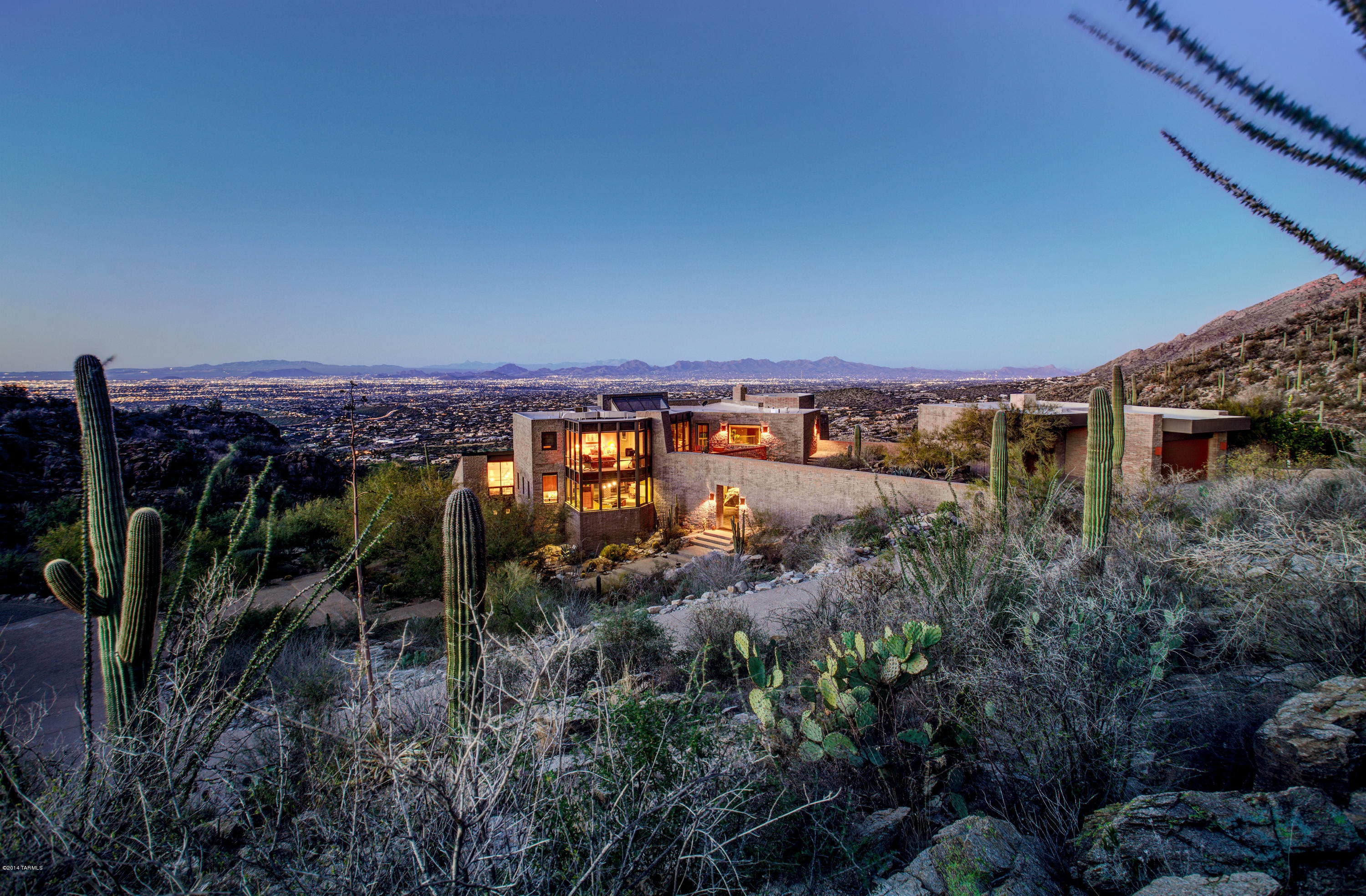 Stunning contemporary on approx 93 secluded acres bordering the National Forest (Beautiful aerial video and floor plan under Photos/Virtual Tour) boasting amazing views, extreme privacy without isolation and pristine surroundings high above, yet just 5 minutes from, world renown Ventana Canyon Resort and Country Club.  Extensive reconstruction done in 2000 and major updating in 2013 including new Wolf, SubZero and Miele appliances, new cherry kitchen cabinet faces, extensive lighting and sound systems, etc. The liv. rm. chandelier is not included, but can be bought by separate bill of sale.  Assessor maps indicate this is the highest home in the Catalina Foothills at approx. 3550 ft.  See documents for solar details. Seller does not warrant the wildlife pond on the subject property. Main house is 5188 sq.ft. and studio/guest house is 862 sq.ft. Westwind Solar (520-349-0622) installed a 13.44 KW PV Solar Renewable Energy "Grid-Tie" system September 2010. Westwind states that the current system provides an approximate $190 reduction on electricity bill when averaged over a one year period at 2010 TEP rates.