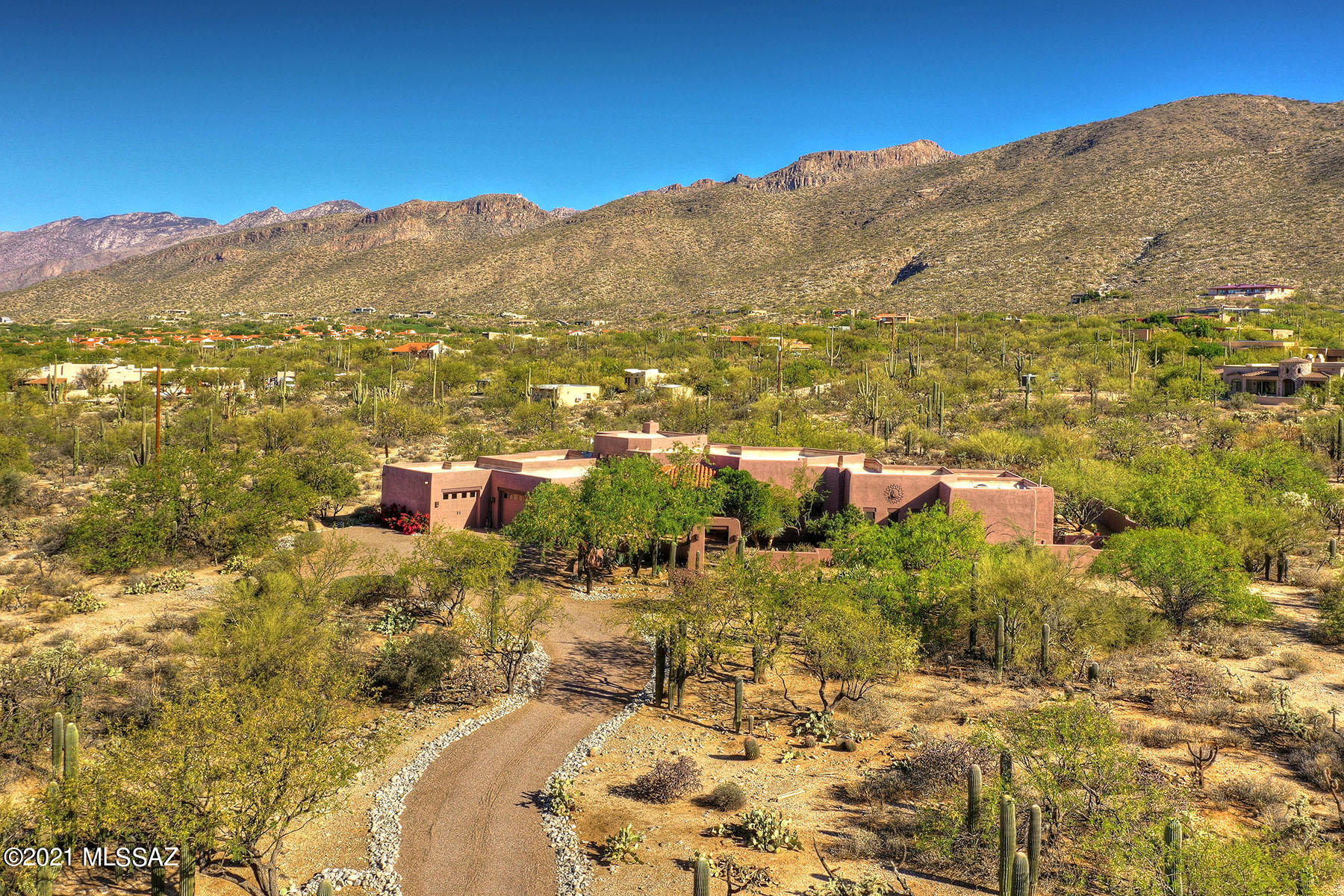 Stunning Santa Fe Home near base of Catalina Mountains offers Spectacular Views. Located on 3.32 Acres in Gated community nestled in Tanque Verde Valley, w/outdoor entertainment areas including Pool, spa & gas firepit. Front Courtyard & Covered patio offer Rincon Mtn & Valley views. 3 bedroom, 2 ½ baths w/office. Bright open floorplan w/rough sawn beam ceiling & saguaro ribs in Great Room & Entertainment rooms. Posts & Viga beams w/Corbels throughout. Great Room w/beehive fireplace & Formal Dining area offer additional living areas. Split floorplan w/Master Suite, office & powder room on one end, 2 guest bedrooms & bath on other.Attached 2 car garage & single car garage, separated by heated & cooled storage room w/cabinetry. A special gem to unwind & appreciate the quiet & beauty of Tucso