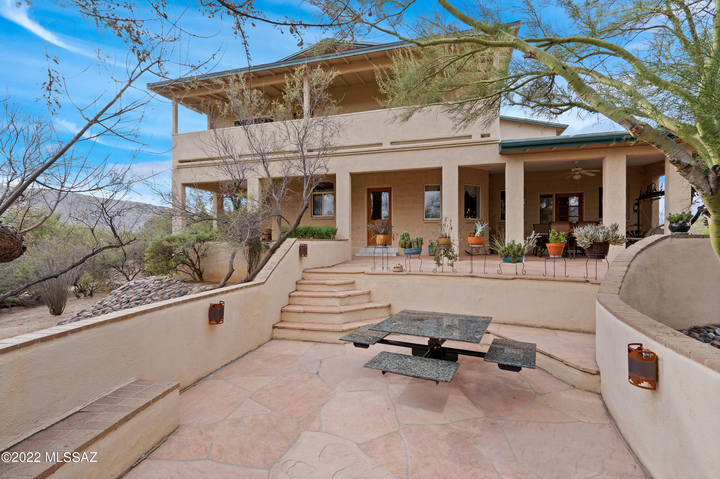 Nestled at the base of Saguaro National Park East in ''The Notch'', 3.60 acre horse property w/majestic views of Catalina Mtns! 2926 SF main house features 4 BR/3.5 BA/2 car garage, wood beam ceilings, kitchen w/gorgeous maple wood cabinetry, granite counters, built-in desk/cabinets. 2 FP, large master suite w/entrance onto view deck. Perfect for outdoor entertaining with spa, flagstone patios, firepit, seating areas. 2 BR/1 BA 1199 SF brick guest house w/4 car tandem garage.  Approx 30' x 30' covered RV shelter, 60 X 150 arena, tackroom, 3 covered stalls-12X20 workshop (1 car garage), covered hay storage. Main house A/C replaced 2017, Guest house A/C replaced 2014, Roof seal-coated 2021. New roof main house 2016, new roof guest house 2012. Guest house new water heater 2020