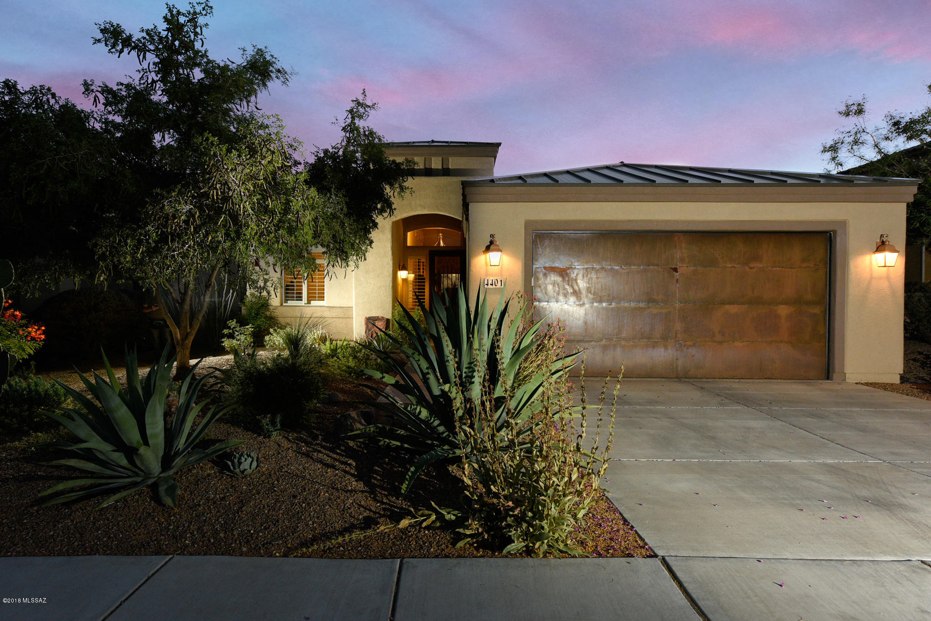 Lovely home , well maintained in gated skyranch! Preserved common area behind property. Kitchen features upgraded cabinets, granite countertops and new SS Appliances. Great room has cozy stacked stone fireplace, dramatic 14 feet high ceiling with high decorative windows bringing in natural lighting. Stunning concrete floors. Back yard is quiet backing up to natural desert where you can enjoy those lovely sunsets sitting in your hot tub. Garage doors are rustic metal facing. Home is like new only been lived in several months a year since it was built.