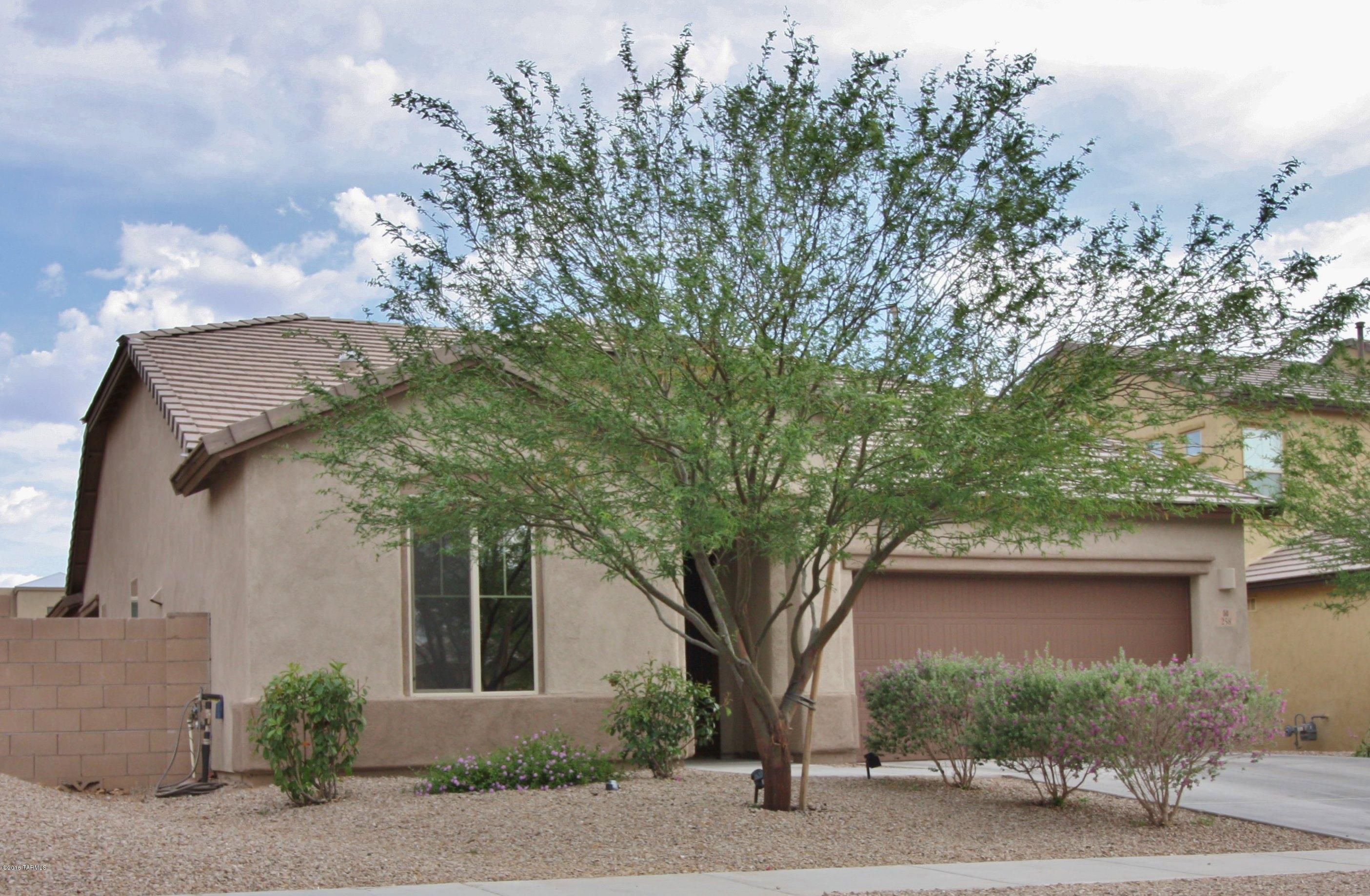 Beautiful 3 year old home features 3bd/2ba + a Den, open kitchen with granite counters, bright spacious eating area, long breakfast bar, stainless steel stove, microwave and dishwasher, solar tube, and tile flooring that covers kitchen, living areas baths,and halls. The property boasts tall ceilings, 6 ceiling fans, tinted dual pane window with blinds, a security front door, and a 2 car garage with pulldown attic ladder leading to extra storage space. Backyard boasts newer 8x10 storage shed, covered patio, and low care landscaping. Located within walking distance to Vail Schools.