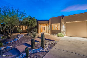 Spectacular views from walls of glass from this custom home in the gorgeous gated community of Sabino Mountain. Enjoy the sparkling city lights and the mountains from almost anywhere in this home. Open kitchen design off of family room which is great for entertaining complete with eat-in nook, breakfast bar, wet bar, SS appliances, beverage refrigerator, granite tops and custom cherry cabinetry. Other features include split bedroom plan, 8' alder doors, cozy contemporary fireplace, stone and granite finishes, several custom built-ins, inviting negative edge pool and spa, expansive covered patio, fresh paint in and out, new carpet and new windows. Home feels like new.  Enjoy the beauty of the Sonoran Desert and the wildlife from this private backyard or when relaxing in the pool or spa