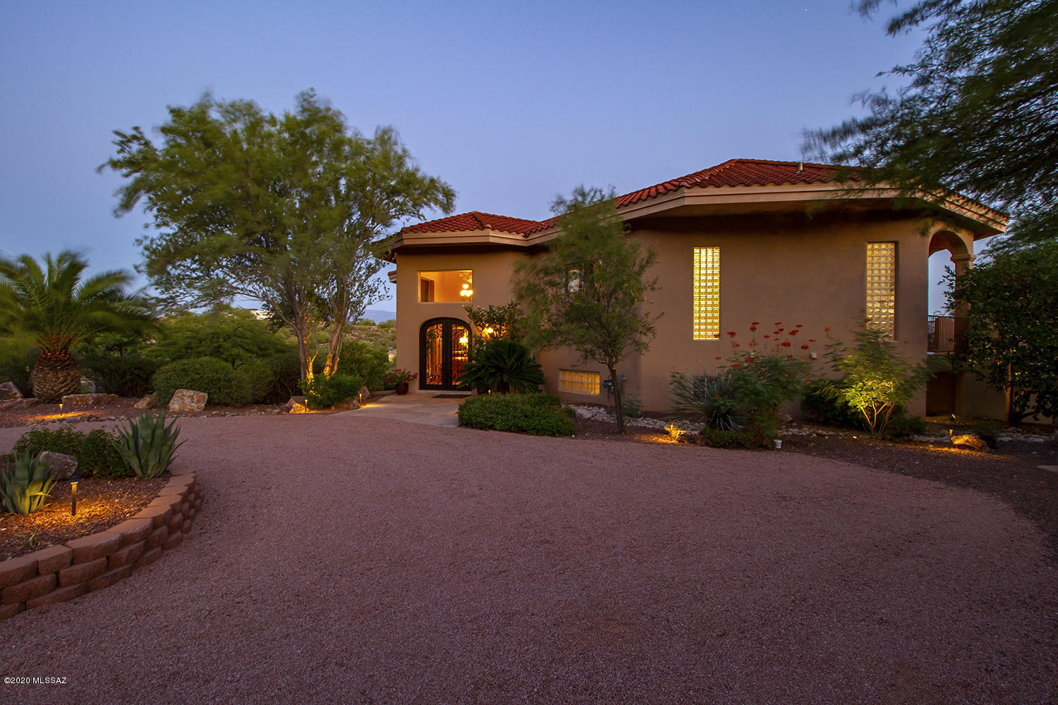 Beautiful, custom, meticulously maintained one owner home situated on one acre along a private, quiet, paved road with spectacular mountain & city views. No HOA. Adjacent to available 1.13 acre lush natural desert vacant parcel MLS #22022844. TEP guaranteed Energy Star efficient home. 36 owned solar roof panels generate an average of $150 electricity savings per month. Media room features include 75'' UHD TV. Self cleaning Pebble Tec gunite pool with rock waterfall. Security system. 18'' Travertine tile most of house. Two separate (new in 2017) AC/Heat pump systems, 1 for each floor. Solid core interior doors throughout. 3D tour includes measurement mode. See Documents for Features, floor plan & more. Please come see this gorgeous, one-of-a-kind home, in a beautiful setting! City views are City views are prominent through six sliding glass and two glass panel exit doors to upper & lower rear patios featuring 22 columns and 12 arches.

Great mountain views are visible from all windows on north side of house, including the foyer, dining room, kitchen, Owner's Retreat office/library, guest bedroom and bath, plus both upper and lower patios.

Upper circular drive access to handcrafted, arched double wrought iron and glass entry door.

Lower drive access to under home two+ car garage with newly epoxy painted floor.

No Homeowners Association. Supporting information in Documents.

Mechanicals and Utilities include

TEP guaranteed Energy Star efficient home with insulated concrete exterior walls. 

36 owned solar roof panels generate an average of $150 electricity savings per month.

Home's North/South exposure, roof-overhang construction and many south-facing windows promote passive solar energy in summer and winter.

400 amp electrical service with 400 amp main panel in garage and 100 amp sub-panels on both floors.

Security system sensors on all movable windows and doors; pool security with override switch.

Two separate water heaters for each end of home, each with a hot water recirculation system to yield immediate hot water multiple times per day.

Two separate (new in 2017) AC/Heat pump systems, one for each floor with AC vents in garage as needed.

2 electronic air cleaners.

Ductwork is located in insulated conditioned space.

Whole house central vacuum system.

Interior Features include

Fifteen foot vaulted ceiling in living room & 18-foot in foyer. 

Eight foot doors and eleven foot ceilings on upper level.

Solid core interior doors throughout.

18 inch travertine tile throughout most of house; remaining is upgraded carpet and pads.

Beautiful Family Room around the gas fireplace with marble bancos on lower level.

Bonus flex space on lower level ready for home gym, yoga, craft space, etc.. 
Cable television outlet here and in multiple rooms.

Spacious office on lower level with gorgeous views and attached ¾ bath easily converted to bedroom with the addition of a closet.

Sound control insulation at baths, laundry walls and between floors 1 & 2.

Three Heatilator zero-clearance direct vent natural gas fireplaces inside. 

Marble bancos/faux painted fireplaces in Owners' Retreat and Family Room.

Custom hand carved Cantera stone fireplace surround and mantel in living room.

Custom made draperies plus sheers in living room.

Four closets utilize door operated lights.

Sturbridge Yankee decorative wrought iron towel bars, rings & toilet paper holders in kitchen and all bathrooms.

Nine interior ceiling fans.

Built-in safe.

Media Room Features include 
Home entertainment system with 75" UHD television with subwoofer/soundbar/surround sound. 
Audio/visual receiver.
Blu-ray DVD. 
Sonos wi-fi sound system with built-in speakers in 4 rooms.

Built in cabinets, countertop, built in sink, under-counter 52 bottle wine chiller and under-counter refrigerator.

Kitchen Features include
Stainless steel appliances including: 
Double conventional/convection ovens
Warming drawer 
French Door refrigerator 
New dishwasher August 2020. 
Five burner glass cooktop with downdraft ventilation eliminating overhead range hood.

Center island with Kohler River Falls deep cast iron prep sink.
Abundant cabinets crowned with egg and dart molding, appliance garage, Lazy Susans.
Large pantry cabinet with four pull out drawers.
Over-cabinet lighting plus under-cabinet countertop work lighting.

Juperana granite on all countertops and built-in desk.

Wet bar with seeded glass front cabinets and under-counter glass door beverage refrigerator.

Owners'  Retreat Features include
Bedroom, Bathroom, Dressing Room and Office/Library. 

The Bedroom has tall windows and sliding door to balcony with an amazing view to city lights. 
Gas fireplace with marble bancos/faux painted surround.
Custom made draperies plus light control curtains.
A remote control ceiling fan.

The Bathroom has dimmable lighting, and floor lighting under large floating cabinets.
Ample drawer space.
Two separated porcelain sinks. 
Florentine granite countertops.
Large corner cabinet with built-in electrical. 
The walk-in shower boasts two shower heads and two glass block walls.
The water recirculation system delivers immediate hot water. 

A pocket door closes bathroom from bedroom, and another adds privacy to toilet. 

Dressing Room has a built-in dresser and floor-to-ceiling closed closets and cabinets.
Ample shoe storage.
Laundry chute to the laundry closet below. 

The Office/Library has a privacy pocket door.
A built-in desk.
Amazing mountain view from the window seat with more cabinets underneath.  
The many built-in book shelves also feature over-cabinet lighting.

Bathroom Features include
4 bathrooms, one is full, two are ¾ and one is a ½ bath powder room
Floating cabinets with under-cabinet floor lighting in Owners' bathroom and powder room.
Granite countertops in Owners' bathroom, powder room, and ¾ bath on lower level.
Powder room has a Florentine granite countertop and a travertine stone vessel sink.
Three walk in showers with glass block walls/windows. 
In the full bath on the lower level the countertop and oversized jetted bathtub are cultured marble, custom made to incorporate the wide windowsill and create a small deck between tub and sink. The walk-in shower floor is matte finish cultured marble as well, and glass block on two sides allows in cheerful morning light. 

Laundry Room Features include
Laundry closet with catcher for laundry chute, plus storage space.
Plentiful cabinets and counter space.
Kohler Irontones deep laundry sink.
Glass block windows.
Television cable outlet.

Outdoor Features include

Mature professional landscaping surrounds the home on all sides.
Artistic blend of cactus, palms, native trees, fruit trees (naval orange, Arizona Sweet orange, and Meyer lemon), ground cover, and shrubs, with boulders, rip-rap, river rock and gravel throughout.

Front yard is terraced with retaining walls, boulders and landscape rock, and lush with many native plants.

Back yard is fully fenced in galvanized fencing painted in desert camouflage. Gorgeous mature trees add architecture and shade.

Self cleaning Pebble Tec in-ground gunite pool with rock waterfall.
Large natural flagstone pool surround, next to brick-lined artificial lawn.

Custom raku totem created and installed by Chandler artist Joe Woodford, plus other garden statuary.
Large ceramic pots line balcony, with drip irrigation installed.

Timer controlled separate drip irrigation systems.
Landscape lighting systems for front and back yards.

Eight exterior ceiling fans on patios.
 
Wood-burning fireplace on rear patio with bancos.
 
Built in natural gas grill and hot/cold water sink. Granite countertop surrounding outdoor grill.
 
Faux flagstone freshly color coated September 2020.
 
Upper balcony and exterior stairs to backyard stained and sealed September 2020. 
Circular stairway freshly painted August 2020.
