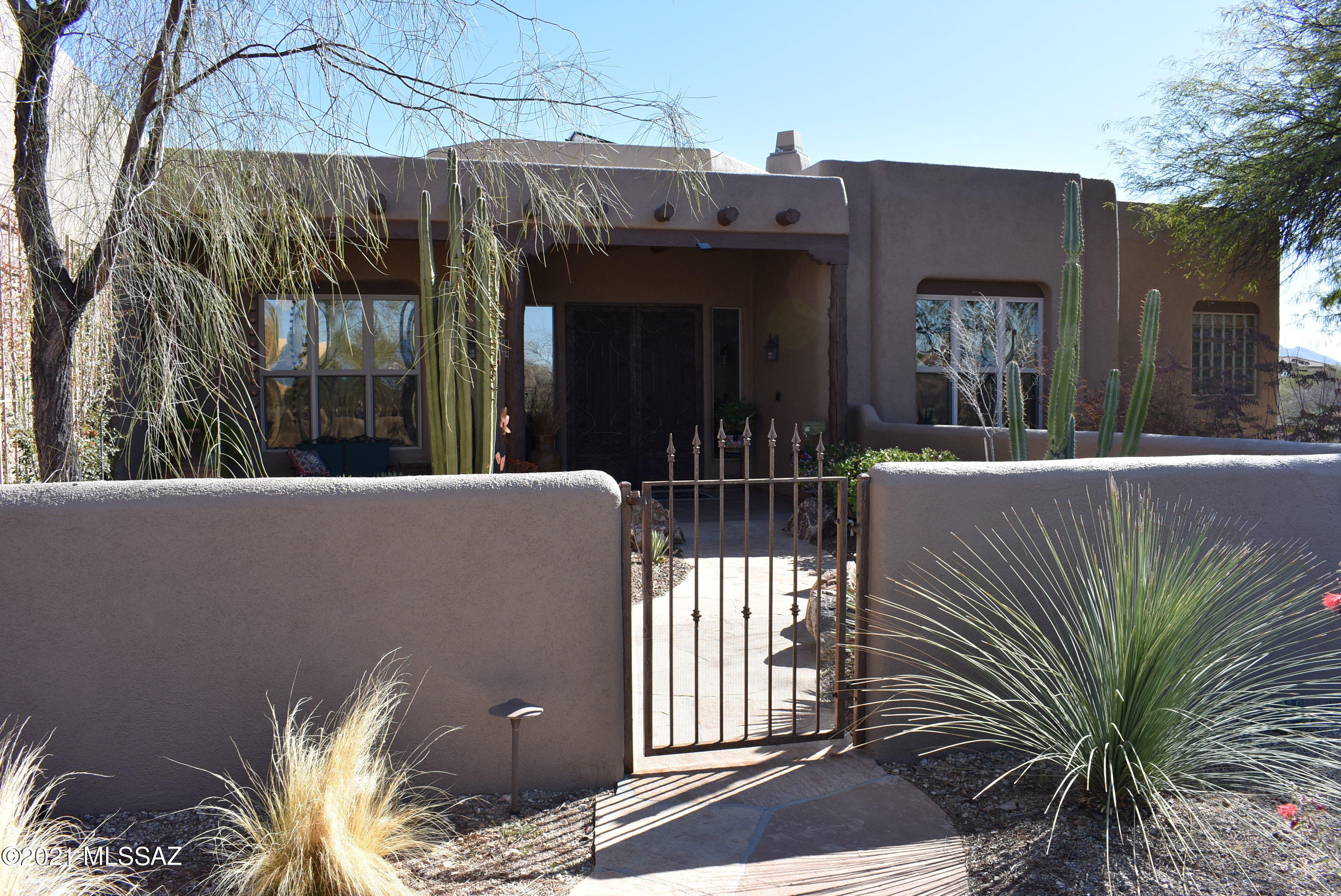 Beautiful TJ Bednar home, on over 3 acres. A breath taking panoramic view of the Catalina Mountains from inside and from the back yard. Split floor plan. With owned solar system. Granite counter tops and stainless steel appliances and an added large wine fridge in the kitchen. Two Beehive fireplaces. An extra room for an office. Gorgeous Viga ceilings in the living. An extra large 3 car garage. The back yard is spectacular, with gorgeous plantings and an out door kitchen, spa, pool, fire pit. If you want to grow vegetables there is even an area for that, just outside the back yard. An extra large 3 garage, gives you plenty of room in this beautiful home.
