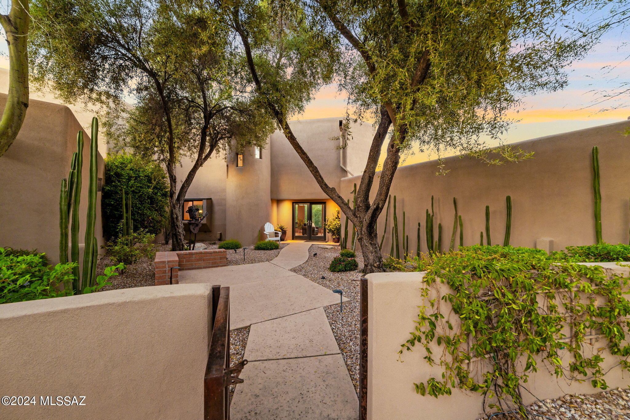 This stunning contemporary home, meticulously redesigned by renowned architect Marc Soloway during an extensive remodel in 2004, is located within the prestigious Ventana Canyon Country Club. Nestled behind private gates, this expansive residence boasts over 4,100 square feet of luxurious living space and is free from the constraints of HOA dues. The home effortlessly blends modern elegance with breathtaking views of the surrounding desert and mountains, offering a tranquil and sophisticated retreat. This is a rare opportunity to experience resort-style living in one of Tucson's most coveted and exclusive communities. Please note: Viewings of this property are strictly by appointment only, following proper vetting.
