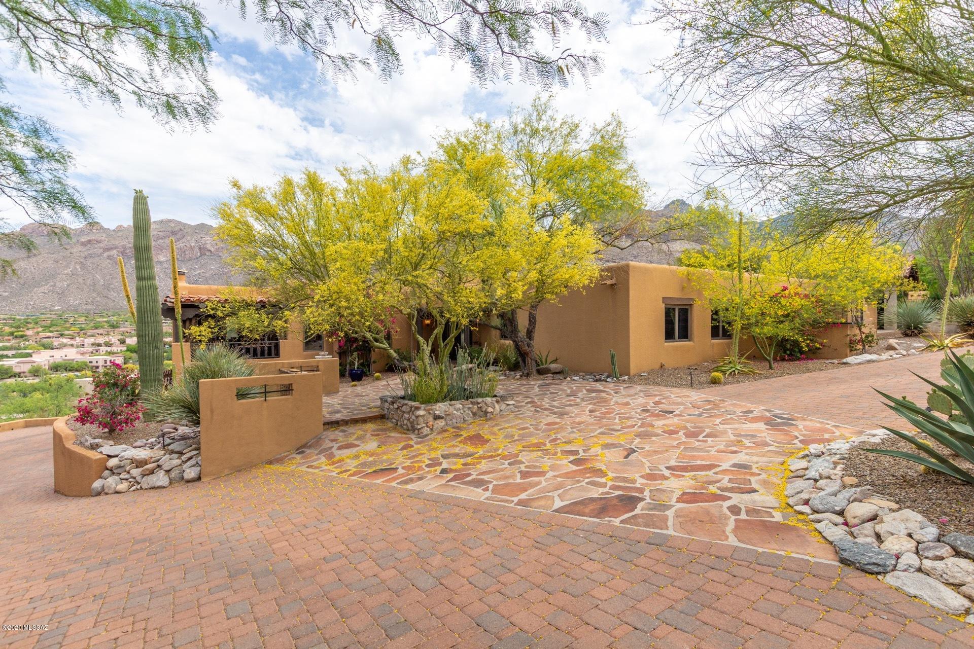 Exquisite and updated w/panoramic mountain views. Grand family room w/soaring ceilings + relaxing living room - both with fireplaces. Wood and beamed ceilings throughout. Home boasts travertine & hardwood flooring, french doors, chiseled granite kitchen countertops, stainless steel appliances, many skylights. New roof in 2016, brick paver driveway, updated polymer decking, solar electric, solar pool heating system, sewer re-lined in 2015, new landscape drip irrigation system in 2016, pool pump replaced in 2014. Home has an elegant ambiance w/views and decks everywhere. Relaxing mega deck + private area patios. Heated pool & spa. Guard gated Sin Vacas provides much privacy.  Weight, Pool Equipment, and patio furniture included. DRONE VIDEO  https://www.youtube.com/watch?v=87qjjcV9MKc&t=5s