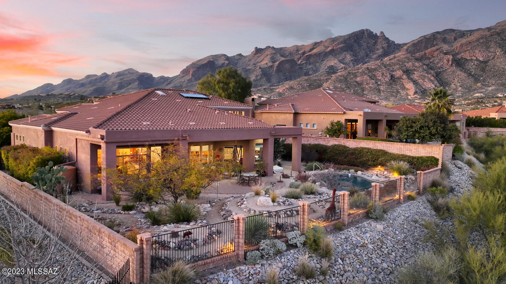 Spectacular 4 Br 4 Ba + Den + Rec Room + 4 car extended garage even includes a Tesla Charger. Beautiful award winning backyard features a Pebble Tec self cleaning pool and zen labyrinth. Wonderful meditation tree with rock seating. Mountain and City views! Fantastic floorplan with a domed foyer, formal living and dining rooms. Primary and Den (could be 5th bedroom) on the main floor. 3 more bedrooms with 2 baths and huge Rec Room (includes Murphy bed and storage cabinets) upstairs. High ceilings, lots of Low-E windows. Custom lighting throughout. Freshly painted inside and out. Very hard to find larger home on a quiet lot in the desirable gated  Paloma Canyon community in the Catalina Foothills School District.