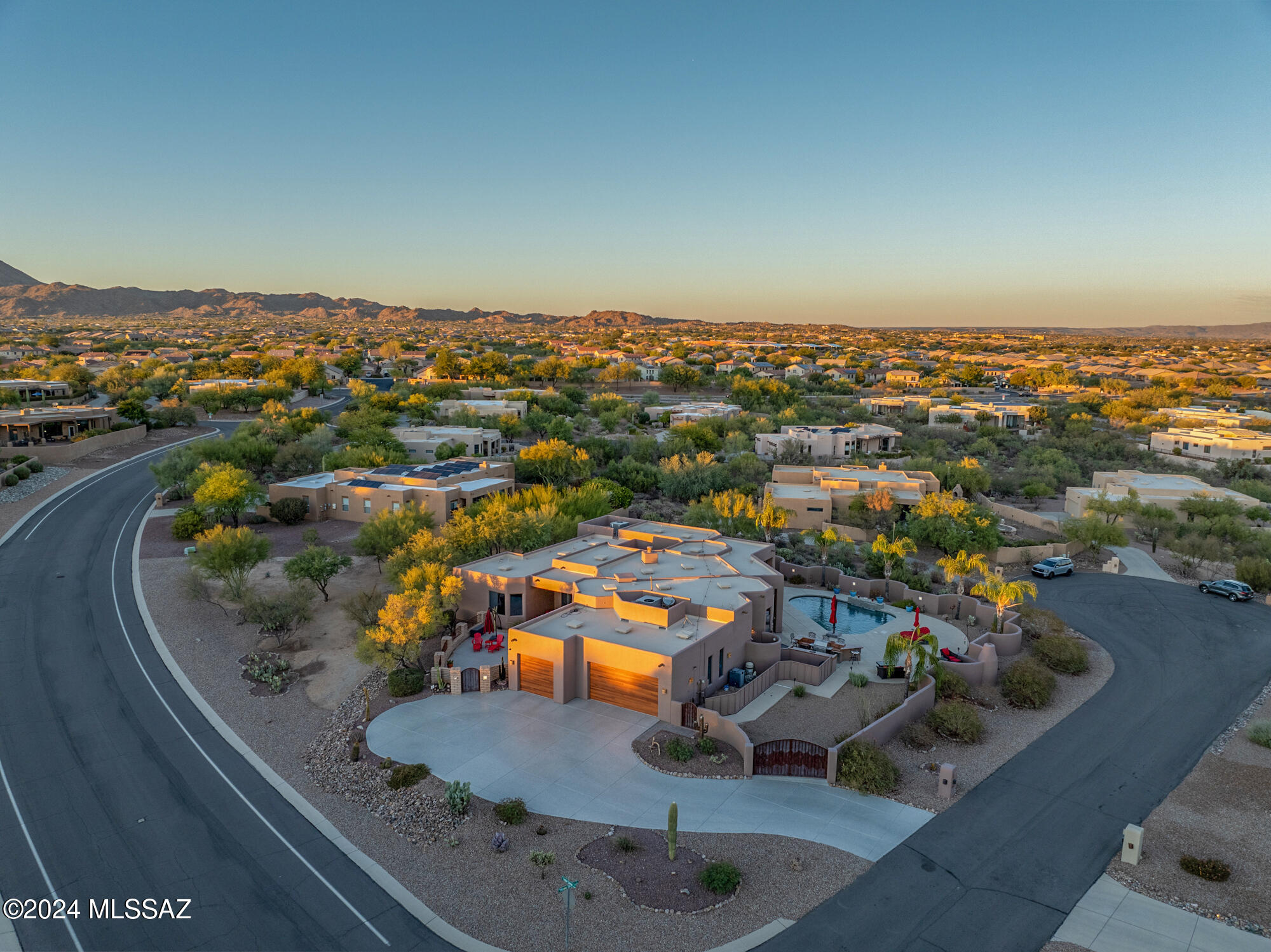 Resurrected Luxury with unmatched views in Oro Valley. Perched on a premium, private corner lot, this meticulously revitalized semi-custom estate marries refined luxury with the vibrant beauty of the Sonoran Desert. Featuring 4 spacious bedrooms, 3.5 bathrooms, and two ensuite retreats, this property showcases both thoughtful design and exquisite detail.

Step through a welcoming entry, framed by a unique cactus waterfall feature into a home where light and panoramic mountain views spill through large windows and soaring ceilings. At the heart of the home lies a tranquil atrium oasis, where sunlight and hummingbirds abound, enhanced by a soothing waterfall and a custom doggie door—a true paradise for four-legged friends! The expansive outdoor space is crafted for both entertaining and relaxation. Enjoy a refreshing dip in the pool, complete with a waterfall feature and a new self-cleaning system. A spacious retreat style outdoor shower offers a spa like touch, while the beautifully epoxied courtyard, driveway, and garage add a sleek, functional finish.

Inside, every detail is designed to impress. The kitchen boasts unique polished steel countertops that harmonize beautifully with a bespoke fridge coveran artistic statement that stays with the home. An updated outdoor kitchen and a meticulously maintained citrus grove of lemon, orange, and lime trees add resort style touches that elevate this property's allure.

Enhanced with two updated HVAC units/ 2021, fresh interior and exterior paint, and a host of continued updates, this estate exemplifies luxury and lasting quality. This is Oro Valley living reimaginedwhere modern sophistication, natural beauty, and desert serenity unite for an unmatched experience. Welcome to the home where OV stands for 
-Outstanding View!