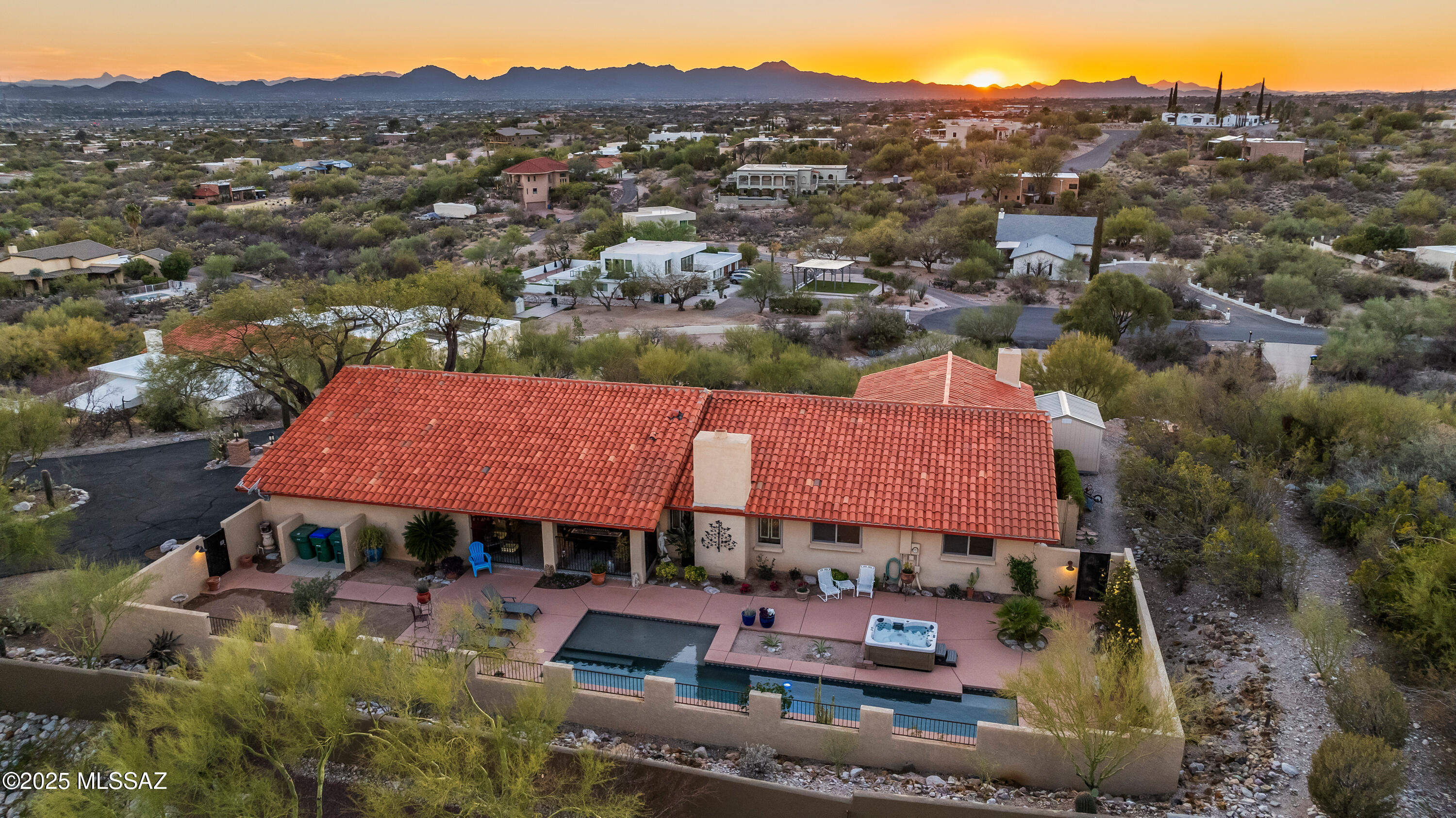 Charming, updated and remodeled, this premium hilltop home comes with stunning views of the Catalina Mountains as well as views across the desert to the downtown Tucson city lights. Nestled deep in the neighborhood away from traffic noise, this 3074 sq. ft. has four bedrooms and 3 full baths; Including a formal living/dining room plus separate family room. The family room is a cozy room with fireplace. Both Family room and kitchen open to a  backyard retreat with pool, hot tub and Catalina Mountain Views! This split bedroom design comes with a guest room and separate bathroom. The HUGE Master bedroom suite w/corner fireplace comes with a private patio and view of downtown Tucson!