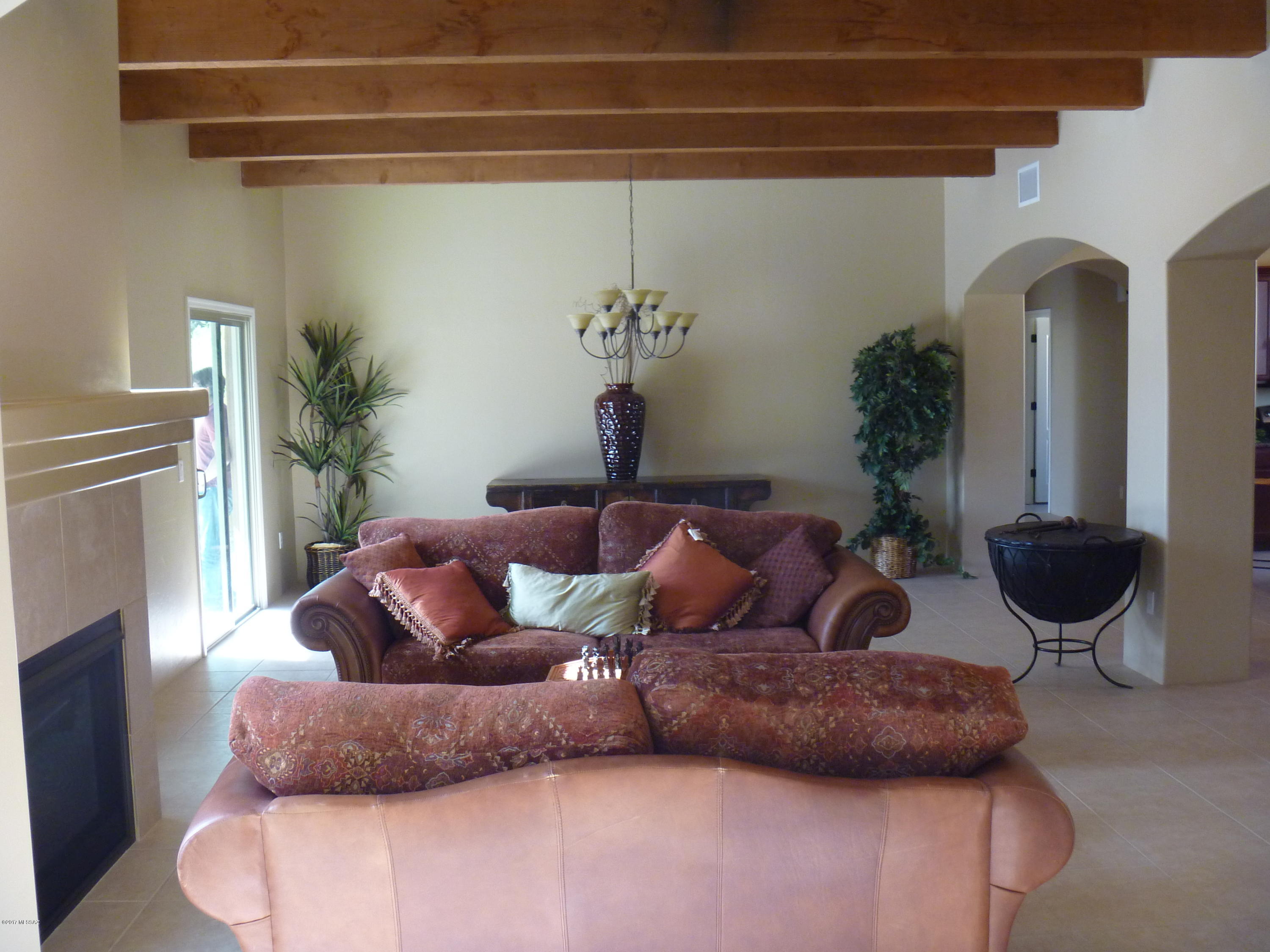 Beautiful 4 bedroom Barrio Style home in quiet central neighborhood near TMC, Basis School and Ft. Lowell Park. High beam ceilings, tile throughout w/carpet in bedrooms. Bright open floor plan w/maple cabinets in kitchen, matching island and breakfast area. Great Room w/fireplace and dining area. Lovely landscaped yard with covered patio, outdoor entertainment area, fireplace & buncos. Separate enclosed area on side yard with double iron gate. Located at the en of the cul de sac.