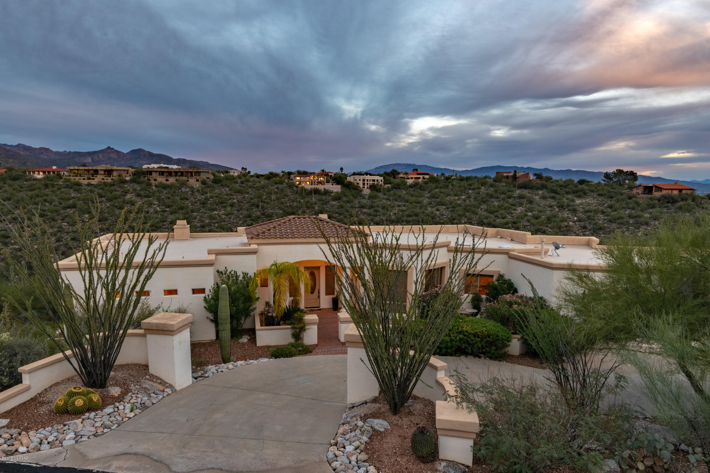 Private luxurious estate sitting on over 2 acres and overlooking the natural desert with spectacular mountain and city views.  This spacious Catalina Foothills property is located in a gated enclave of only 13 homes and features a secluded backyard with heated pool & spa, bbq area and low care landscaping, numerous patios all with breathtaking views, 3 car garage, expansive windows throughout providing an abundance of natural light, master suite with walk-in closet, sitting area with romantic gas fireplace, open eat-in kitchen with granite counters, pantry and center island, zoned heating & cooling, recently replaced ceramic tile flooring & carpeting on 1st floor, laundry room with washer/dryer & sink and a convenient Northern Tucson location near shopping & numerous restaurants.