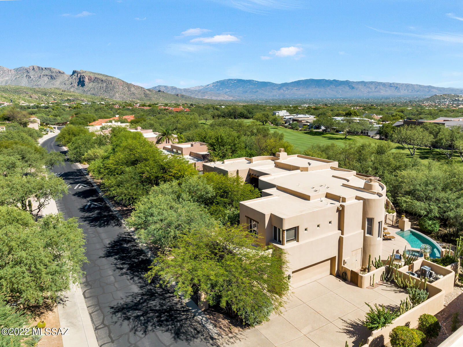 A One of Kind Masterpiece!!!  This spectacular Santa Fe custom home is located on a secluded lot adjacent to the fairway of #1 hole at the MTN course.  This home is perfect for entertaining your family and friends with 2 spacious master suites, media room, library, an elevator, two impressive wooden staircases, many custom built-ins and a gourmet kitchen. The outdoor spaces are just as impressive with 4 patios,2 covered decks, front yard walled in courtyard, an infinity edge pool with spa, water feature, two outdoor fireplaces, built in BBQ .  This property is truly a private oasis with lush landscaping with a large selection of cactus, mature trees and beautiful sunsets. In August 2022, the owner installed all new Rheem energy efficient HVAC equipment.  See in the documents section.