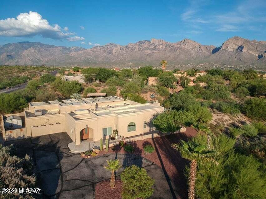 Seller will accept or counter offers between 775K-800K. Seller accepting back up offers. Home appraised at 825K 4-26-23.  This custom home sits on over an acre in the heart of Oro Valley, with 3499 SF of living space. Open floorplan, vaulted ceilings, kitchen features breakfast bar and prep sink, built-ins in dining area, and great room. The great room features a stacked stone fireplace, wet bar with beverage refrigerators and two grand picture windows, lots of natural light. Two master suites both with private entrances and large walk-in closets. One suite has an additional room attached for use as an office, nursery or second walk-in closet.  With a little imagination and updating this home could be exactly what you're looking for! The backyard is a desert oasis with a beautiful sparkling pool and spa! Upper and lower patios with outdoor fireplace, area for BBQ grill, built in table. Side yard has a double gate. City view to the South, a glimpse of the Catalina Mountains to the East. This home is a must see, the possibilities are endless!