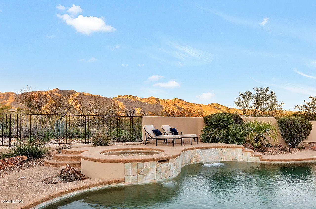 Single story Contemporary home in the Catalina Foothills, nested in a secluded, 5 home, Gated Community. Newly painted inside and out. 5 BR 3 full Baths, sits privately on .84 acres. Open Floor Plan, high ceilings, impeccable Catalina Mountain views. Pebble-tech pool with spay, stacked flagstone outdoor fireplace/banco, gas fire pit and outdoor built-in BBQ area. Truly a wonderful entertaining outdoor space. Gourmet kitchen with top-notch appliances, Alder doors, Maser suite situated in its own wing with fabulous mountain views and dual walk-in closets. New carpet in all Bedrooms, ample 3 car garage plus additional parking spaces on property. Lots of lush mature landscaping with total privacy. Newer AC unit, new irrigation system. This home has been meticulously cared for and maintained.