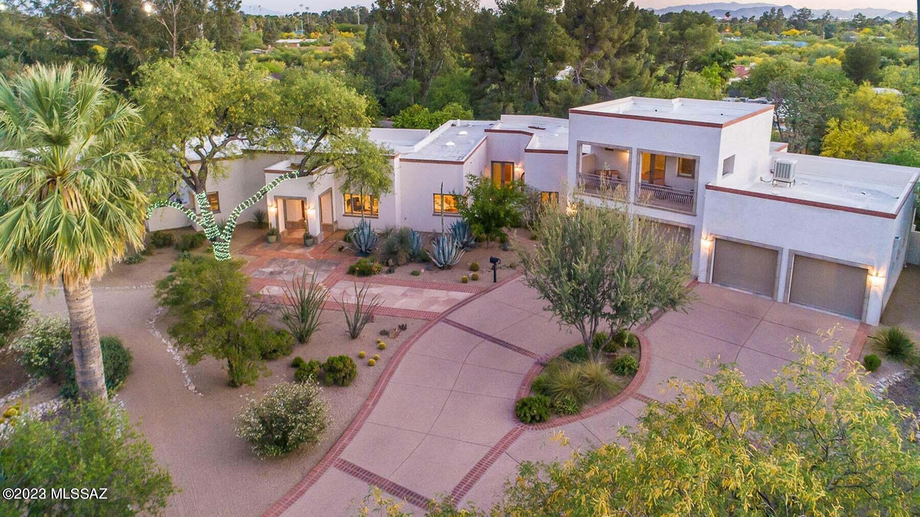 Nestled within this historic & sought-after Colonia Solana neighborhood, this exquisite property offers a lifestyle of unparalleled elegance! Boasting an array of captivating features, such as ICF & masonry construction, heated/cooled 4 car garage, 10ft ceilings & travertine floors.  The property offers a flexible floor plan with 3 bed, 3 bath main house, along with separate 1 bed, 1.5 bath guest quarters.  Wine connoisseurs will adore the temperature-controlled wine cellar. Spacious corner lot (nearly an acre!) offers separate yards for each home, a covered patio, real grass, fruit trees & a fully fenced private yard. There's room for your dream pool or an RV. Currently connected to private well & access to city water, providing flexibility & convenience for your water needs. This IS it!