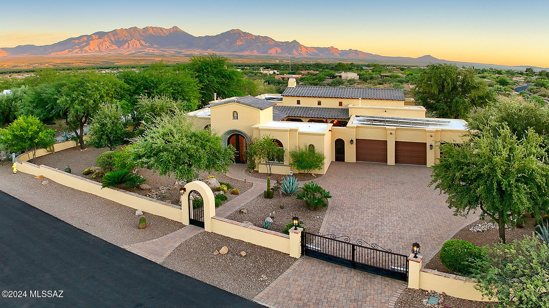 As you become ready to redefine life on your own terms, consider this luxurious estate right in the center of Green Valley! Discover a desert oasis where you can enjoy absolute privacy while relaxing on your pool deck and still bike to town for your morning coffee. Combining elegant, refined interior and outdoor spaces with gracious proportions and unbelievable views, this home offers you the indoor/outdoor lifestyle you have been waiting for. The curb appeal is impressive with interesting architectural details, custom iron gates, paved drive and magnificent front courtyard with its own dramatic lighting and stone fireplace.  
Inside, the Santa Rita Mountain VIEWS pour into the living areas through oversized windows, along with abundant natural light. A sparkling pool and spa are the focal point of the magnificent back yard, overlooking a wash and those incredible mountains.  Inside, The enviable list of amenities that this home offers is endless.  The highly upgraded kitchen features luxurious cabinetry, Miele appliances, copper sink and a sub zero refrigerator with cabinet overlays.  A wine and beverage bar is adjacent and features its own sub-zero wine frig, drink refrigerator, and cocktail glass storage. A large stone fireplace commands your attention and anchors the room.  French doors lead out to the gorgeous front courtyard and the separate guest casita.  Your owner's suite is oversized and luxurious with a walk-in tiled shower and soaking tub.  Two extra bedrooms and a guest casita in the courtyard offer options for any lifestyle.....his and her offices, craft rooms, grandchildren or winter visitors.   One of the most impressive homes in Green Valley, exemplifying the art of a joyful and graceful desert lifestyle!