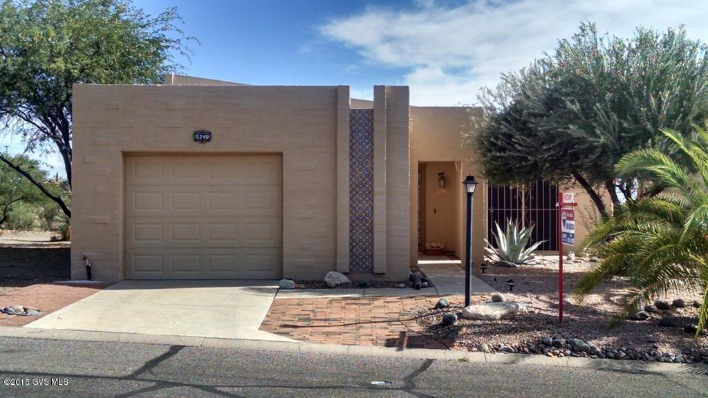 This is a free standing home on a large corner lot backing to grand arroyo with wide open skies and lush desert back dropped by northerly views of the Santa Rita Mountain Range and the valley floor. Easy for snowbirds to lock and leave yet plenty spacious for full time living. Guest parking across the street & rec center nearby. Popular floor plan has breakfast nook in the kitchen, spacious living/dining room plus an Arizona room with French doors leading into master suite with a large walk-in closet. All updated in 2010 including counter tops, faucets, all kitchen appliances, light fixtures & ceiling fans. Flooring is neutral ceramic tile everywhere except the 2 Bedrooms with new carpet. New garage door & roof in 2011. Private side and back yards and intimate spot in front entry as well.
