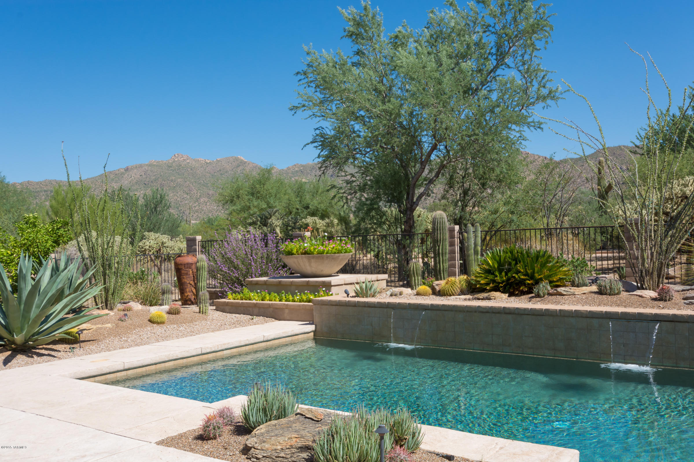 Fully furnished luxurious Distinction-Semi-custom Dos Lagos at Dove Mountain. Situated on 17th Ladies Tee, South Course, Gallery Golf  Club, yet, offering  privacy & majestic Tortolita Mountain views. This home boasts 3541 (+/-)sf on over 1/2 acre. 3 Bedrooms, 3.5 Baths, Den or Optional Bedroom, 3 car garage w/Rustic garage doors.
Pool/Spa/OutdoorKitchen/Conversation Fire Pit. Travertine throughout, Gourmet greatroom kitchen w/walnut cabinets, GE Monogram appliances & double oven. Wine/drink refer. Split floorplan, Dramatic 14 ft ceilings, Raised Fireplace in Living Area, Master Bath w/ separate sinks in travertine, luxury soaking tub, Walk-in shower w/ dual showerheads, Two walk-in organized closets in master, Custom paint, designer draperies. Turnkey ready, call for private showing.