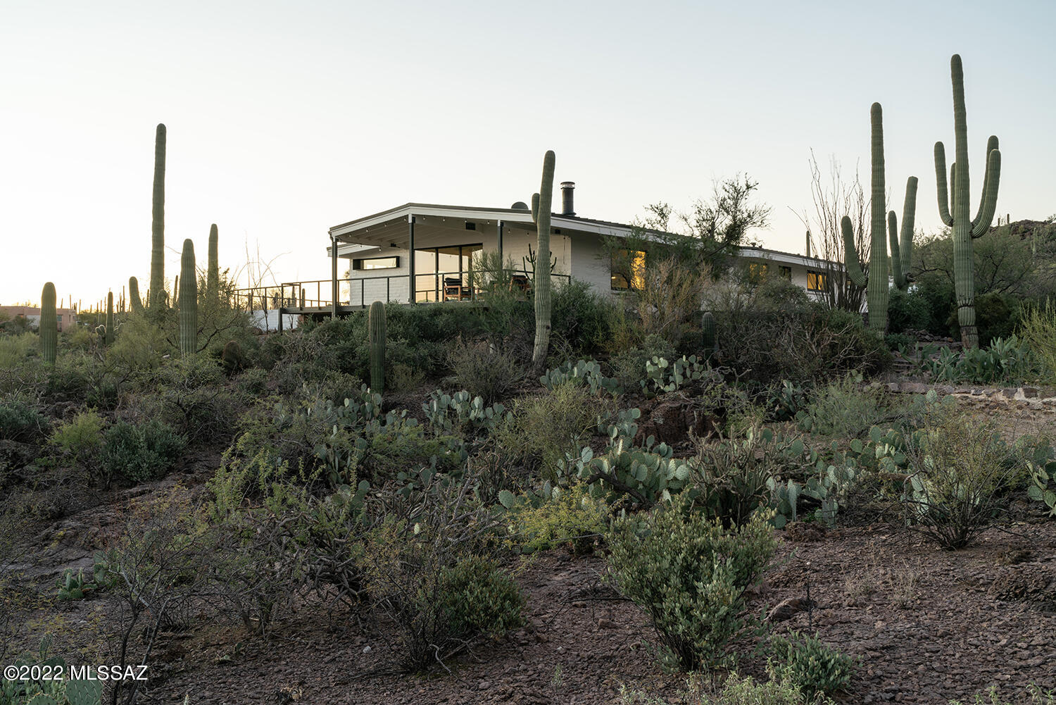 Situated on the Westside on over 3 acres, with majestic views of the mountains and surrounding landscape, this tastefully updated modern adobe ranch is nestled into the site. Upon entering the home, the open living, dining and kitchen allow for a feeling of expansion and flow throughout the space. Considered placement of sliding doors and windows bounce natural light while capturing dramatic vistas – both large and small – in all directions.
This 4 bedroom, 3 bath home received a full upscale renovation that was completed in 2019. A simple material palette of wood, steel, smooth white walls and a selective use of color offer a timeless sensibility that complements any personal aesthetic. Anchoring the home are many special details and moments designed and fabricated by several established local craftspeople - from the custom walnut entry door, the concrete and steel fireplace and additional custom steel and wood work throughout.  
The gourmet kitchen offers ceaserstone countertops, high end appliances, plenty of storage and a separate bar area.  The main owner's suite includes a spa like bathroom with a walk-in shower, plenty of storage and sliding doors that open onto the pool and patio area. 
The addition of an elevated covered patio is an extension of the living room and is perfect for morning coffee, a mid-day yoga session or end of day reflection while you watch the reverse sunset bathe the Catalina's in a dusky pink glow.  
Updated pool, new pool deck and pavers, new shade trellis, new hardscape and native landscaping allow for year round enjoyment of the Sonoran desert's indoor outdoor lifestyle.  A quiet sanctuary in the desert, moments away from hiking and biking trails, while still in close proximity to downtown tucson.

see list of upgrades and floorplan located in documents