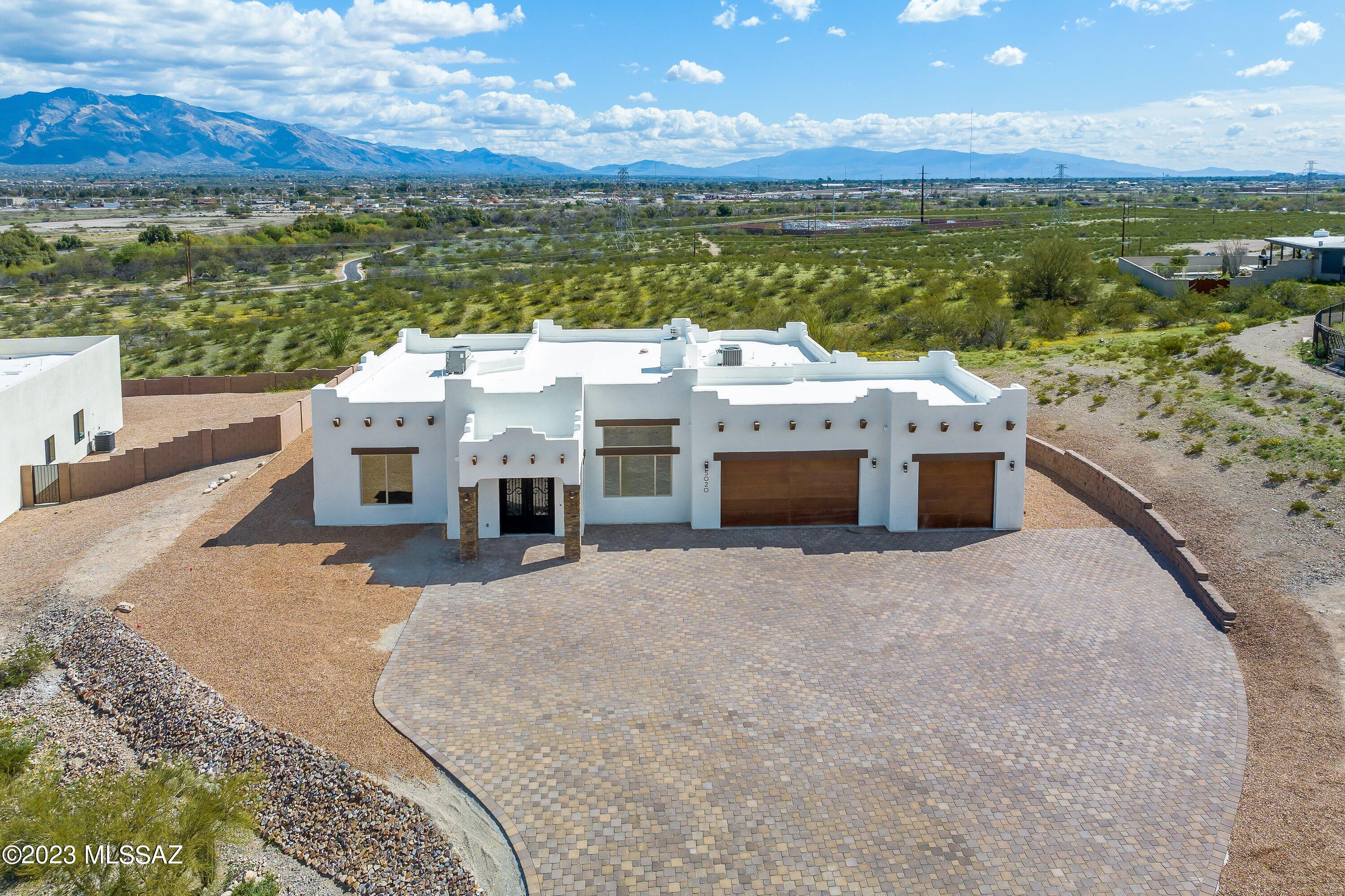 $15,000 SELLER CREDIT for window coverings, landscaping, etc.  Panoramic mountain & city light vistas from this acre view lot. Adjacent to the bike path. Spacious, open, split floor plan w/four bedrooms plus a media room/office. Features include a whirlpool bath; soft-close cabinets; stainless Frigidaire Gallery appliances and hood including a 27.8 cf. fridge; gas & electric ovens plus microwave; pot filler; 10 ft bedroom and 12 ft main room ceilings; eight-foot entry & interior doors; gas/wood fireplace; dual Rheem HVAC systems; living room, media room and master BR wired for surround sound; 11 ceiling fans; 12 fluorescent fixtures on five zones in the garage;  lots of room to entertain, inside and on the large covered patio which has a connection for a natural gas grill