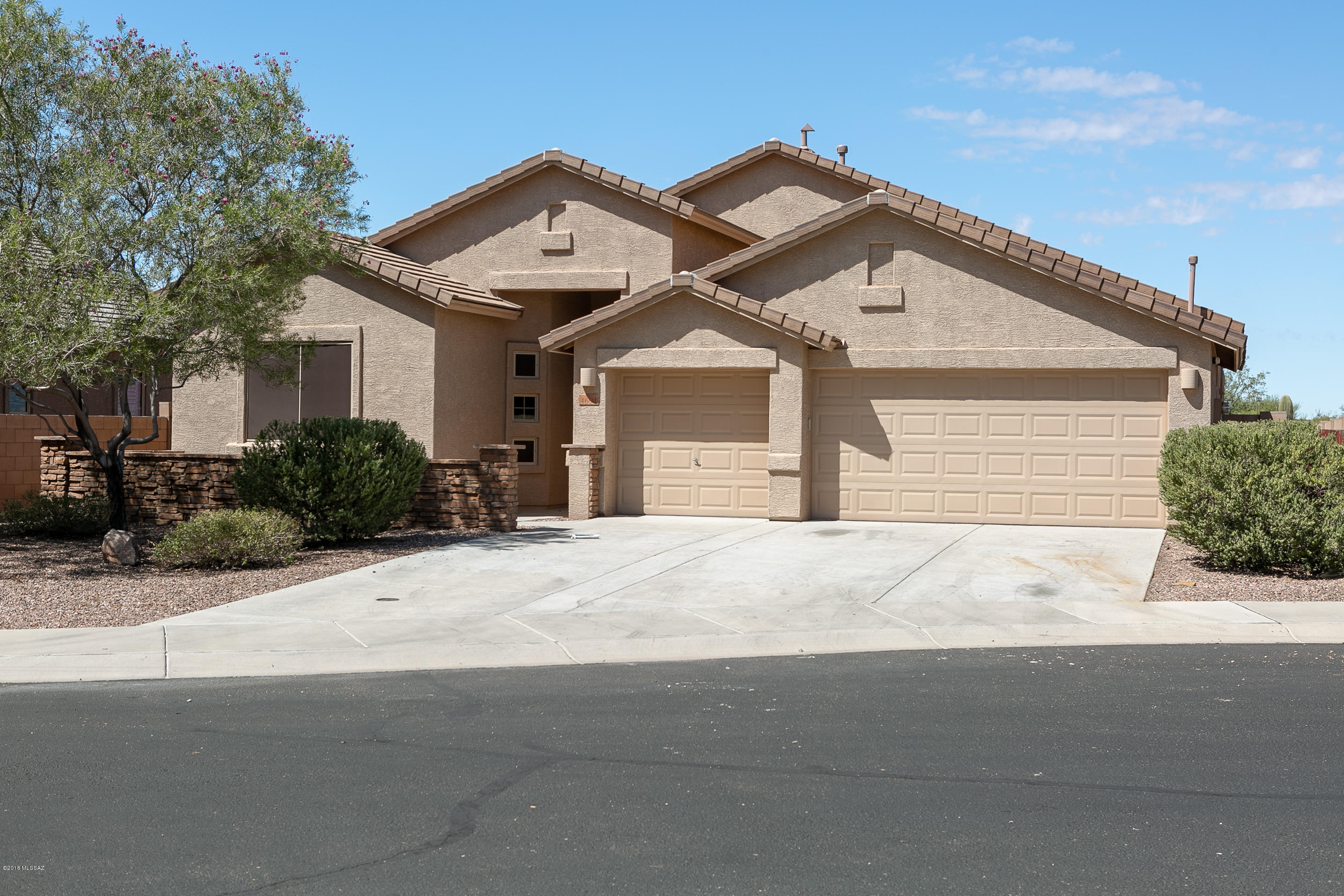 Nestled within the highly sought after Dove Mountain area, at the end of a peaceful cul-du-sac. This home has a brand new coat of paint inside, new carpet with built in BBQ overlooking the Tortalita Mountains. Our home has access to walking paths, jogging paths and many green spaces. A 3 car garage, spacious open great room, generous amounts of kitchen cabinets. Island with sink and breakfast bar are just some of the upgraded features within. Our lovely covered patio with huge backyard is perfect for entertaining in the late afternoon while you see awesome sunset views and great for coffee in the morning while watching majestic mountain views from 3 different mountain ranges. Our huge walled in backyard with side gate is perfect for the installation of a pool. Priced for immediate sale.