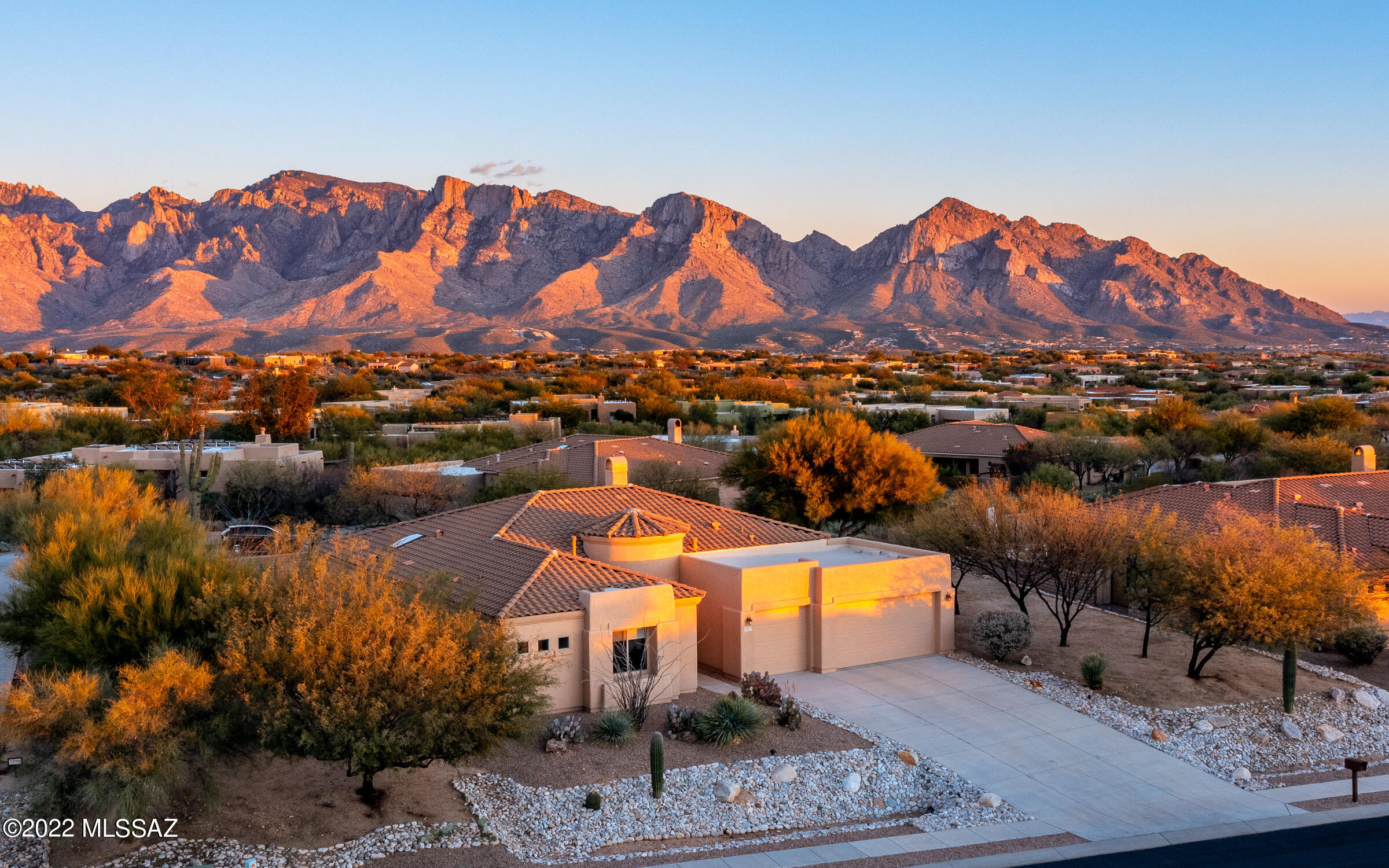 Sweeping mountain views surround this exceptional Vistoso Highlands home. As you enter through the vast foyer, the arched picture windows capture these amazing views! Gourmet chef's kitchen will entice you to prepare fabulous meals, offering GE Monogram appliances, large center-island  & extra cabinets for storage. Kitchen shares casual dining space & large walk-in pantry. Relax near the stunning sandstone fireplace with remote convention heating system. Split bedrooms offer privacy for you & your guests. Master suite has two oversized walk-in closets & separate shower. Retreat outdoors and entertain under the deep covered patio with power sunshade or by the soothing waterfall, pebble tec pool & BBQ grill. Sited on a wide open space between neighbors, beautifully landscaped in front/back and fresh exterior/interior paint. A true desert retreat!