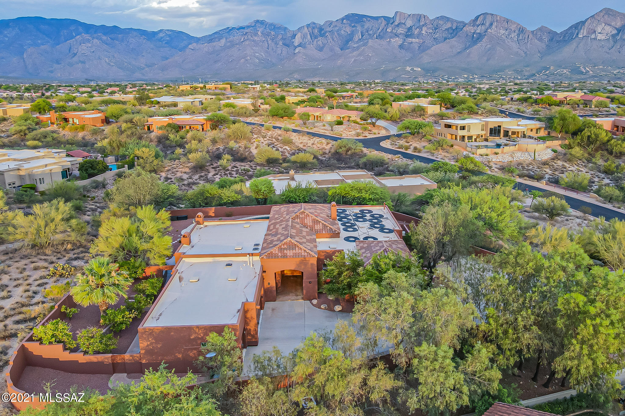 Spectacular 4BD/3.5BA (3,461 sq ft) homesite boasting luxury amenities and mountain views. This elevated home on one acre offers vaulted ceilings, oversized picture windows for viewing those amazing mountain views, Alder doors, foyer, an open and spacious great room with media wall and gas fireplace, formal living and dining with gas fireplace and custom bar area, guest quarters, 24'' honed slate flooring in main areas, carpet in bedrooms, Dacor 6 burner gas cooktop, double ovens, walk-in pantry, huge island with breakfast bar, French door refrigerator, stainless appliances, breakfast nook, private owner's wing with coffered ceiling, huge walk-in closet, luxurious bath with jetted tub, large walk-in shower with dual showerheads, dual sinks and linen closet.  Home Office with French Doors. Central Vac, Water Softener and RO.  Large laundry room with utility sink and full-length storage cabinets.  Magnificent outdoor setting boasts a solar heated saltwater pool with lagoon and spa with rock waterfall, outdoor shower, fireplace, and orange/lemon/grapefruit/limequat trees.  Watch the Catalinas change glorious colors near sunset.  Extended 3 car garage plus separate 2 extra parking spots for guests in the driveway.  Perfectly situated in the heart of popular gated Reserve at Coyote Ridge.  See attached Features List for more information.