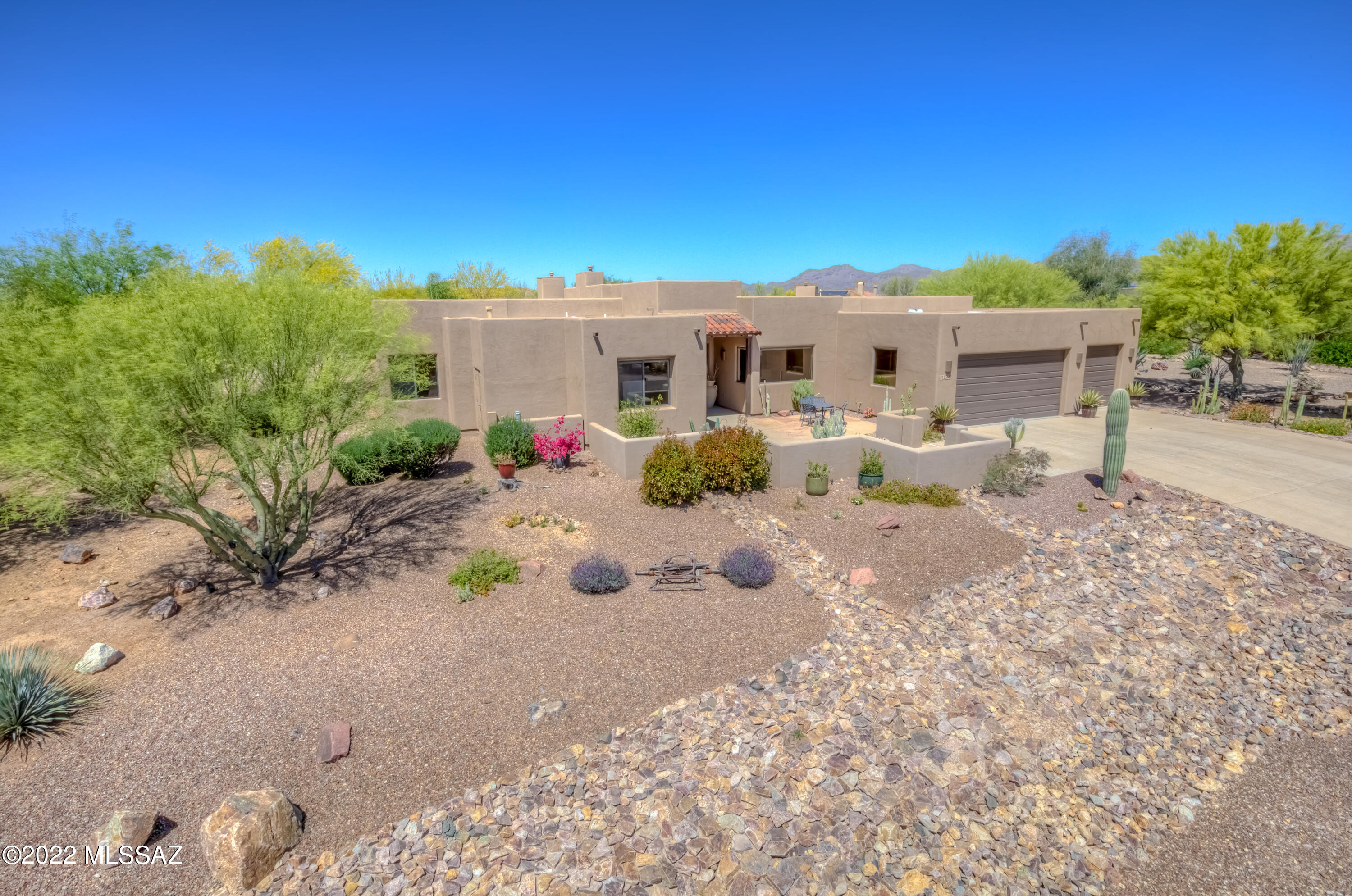 Exemplifying the Arizona lifestyle this semi-custom contemporary home sits on just under an acre, features private, open space & wildlife abound. The open concept plan & attention to detail throughout encourage grand gatherings w/fully equipped wet bar, built-in glass doors that seamlessly blend indoor/outdoor living. Create lasting memories in the luxurious backyard oasis showcasing a comfortable media area, gas fire pit, built-in bbq & sparkling pool w/new heater. The well-appointed kitchen features granite counters, newer wolf stove & vent hood, custom Alder cabinets w/pull-outs, recessed lights, a large breakfast bar & opens to the relaxing & inviting great room. Lg Primary Suite w/jetted tub. Make this your dream home as easy as 12345. See attached feature sheet for more details