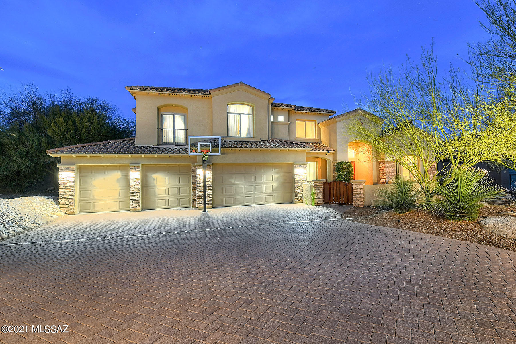 Designed for the Good Life! Well appointed backyard by REALM & featured in Tucson Home & Garden magazine. Relish in the resort-like backyard all year round w/wading pool, spa, hardscape & sunken banco style lounge area including fire feature & waterfall. Beauty unfolds thru-out the interior from soaring ceilings lit by sparkling chandeliers to contrasting crisp white freshly painted cabinets in  gourmet kitchen w/island & breakfast area. Formal dining rm nearby for large gatherings. Relaxing living room has custom hearth & mantel. Master suite downstairs w/emphasis on style & comfort offering jetted tub, double vanities & his/her walk-in closets. Trendy media room & 3 guest rms upstairs. Enveloping the residence are a number of outdoor tranquil living spaces w/majestic vistas.