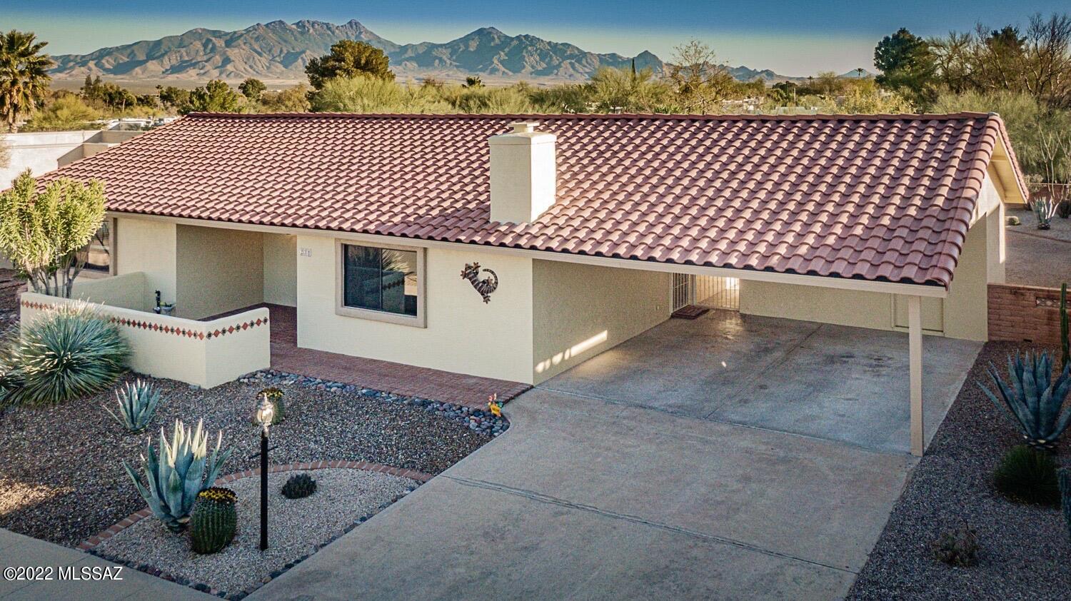 Updated 2-BR 2-BA home w/spacious inviting kitchen, maple cabinets, white appliances, large center island, ceramic tile, and views to the private backyard.  Kitchen opens to a large dining area and adjacent great room with fireplace. Expansive lot with NO rear neighbors, mountain views, covered patio and landscaped yard with palms, cacti, & agave, Over $ 23,000 in roof enhancements in 2021, including completely new roof on back patio and new underlayment on tile roof, with 5-year warranty, plus new skylights too. Exterior professionally painted 2021.  Bryant HVAC installed in 2016. Ideal location in Green Valley's Country Club Vistas 2 - low HOA dues of $ 30/year, and sidewalks throughout. No GVR (NO Green Valley Rec) but is available if desired