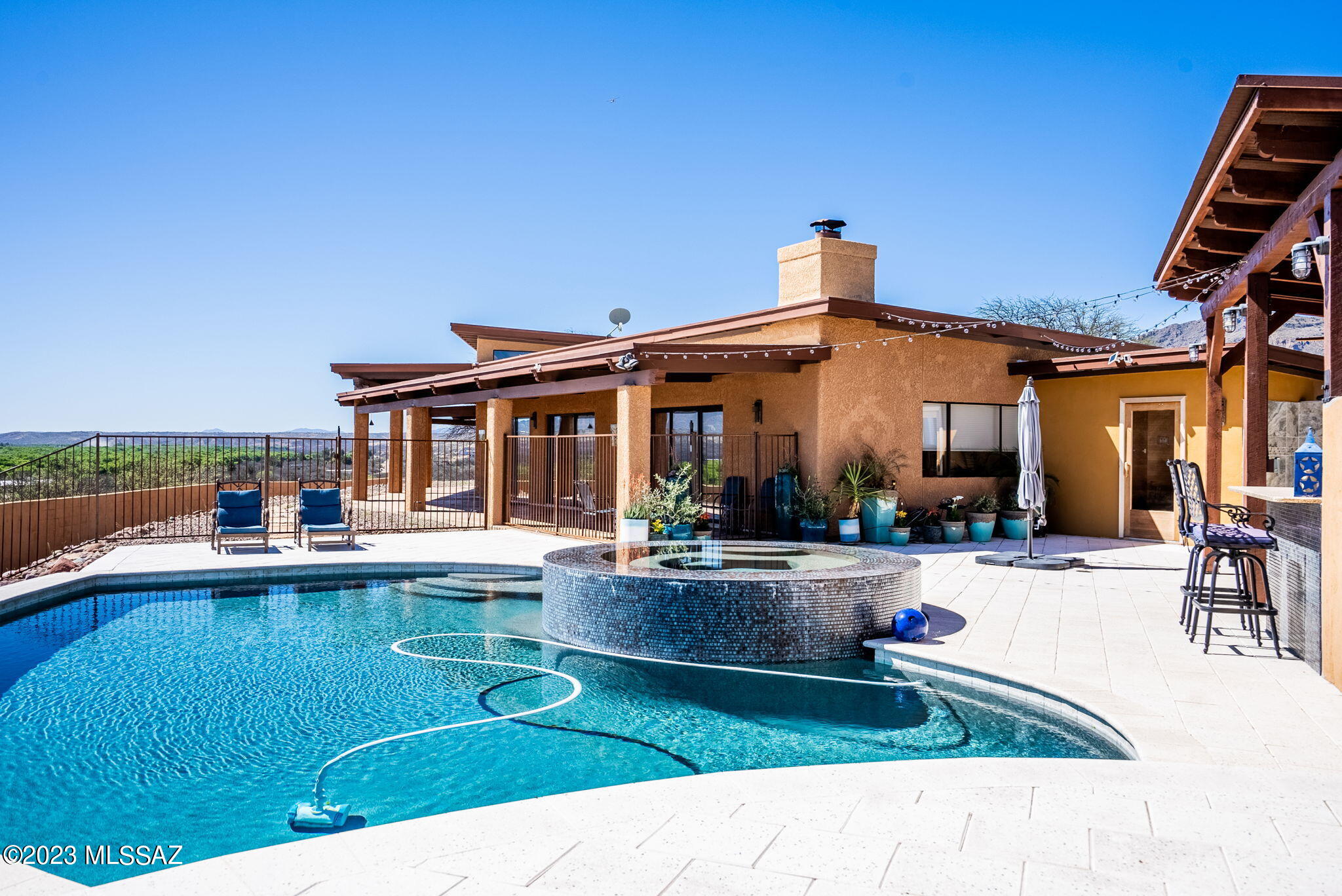 With views of the entire Santa Cruz River Valley, this home is stunning!  The home has been remodeled and includes a casita unit with its own entrance and with a full kitchen and its own washer and dryer!  Great rental potential. The owners have added a new pool, outdoor barbecue,  patio and sauna; this home is like being at a resort and you don't have to leave. Situated on over 1 acre of land with NO HOA!!  The patios offer unobstructed views of the Santa Rita, San Cayetano and Tumacacori Mountain Ranges!! The home also has an RV garage that can be  used as a hobby room or shop and has its own mini split! Everything you need to start living your best life.