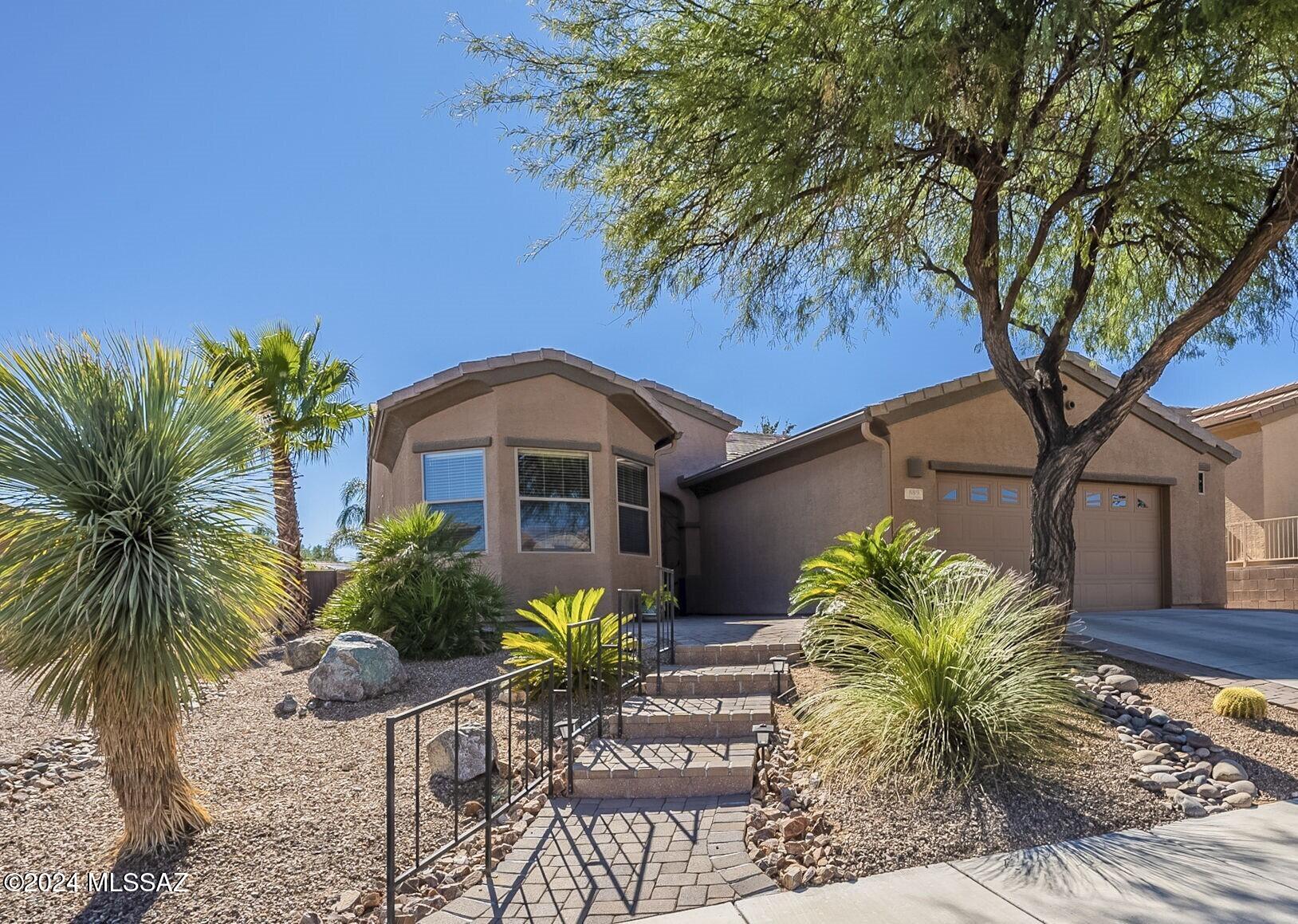 Discover your own slice of paradise in Green Valley! Designed with the discerning retiree in mind, this home offers the perfect blend of indulgence and coziness for those who enjoy relaxing by their own backyard pool.  This solar-owned home isn't just a symbol of sustainable living; it's your ticket to an endless summer.  Step into an open floor plan that speaks volumes of modern elegance, featuring a spacious living area filled with natural light. The heart of this home is undoubtedly the kitchen, boasting beautiful cherry cabinetry, sleek quartz countertops enhanced by a tile backsplash, a convenient island with stylish pendant lighting, and stainless appliances that promise to inspire your culinary adventures.  The den is the perfect place to do your computer work and keep yourself organized while enjoying conversation with others in the kitchen.  The split bedroom arrangement ensures privacy and comfort, with the guest room thoughtfully expanded to include a charming bay window area.  Outside, your personal oasis awaits - swim in your private swimming pool or practice your putt on the putting green. The backyard is designed for leisure and entertainment, promising endless enjoyment under the Arizona sun.  Welcome to your dream home, where every day feels like a vacation.