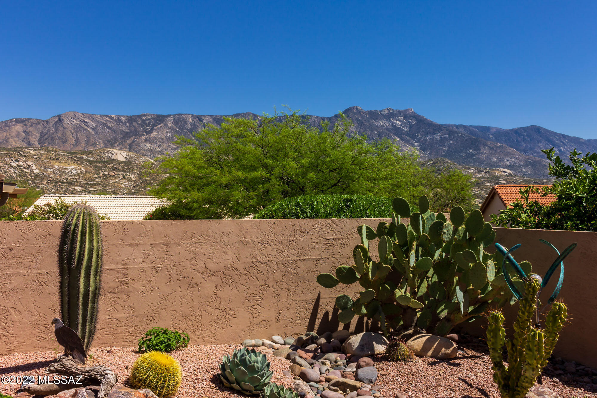 Elegant, Classically Updated thru-out, Barcelona Model w/Casita & Back Mountain Views. This Contemporary Home Enjoys an Air of Elegance which Few Homes Have. From the Beautifully Paved Driveway, Enter Your Private, Gated & Paved Front Courtyard w/Casita & Ramada. Remodeled White Kitchen w/Granite Counters & Island w/Veggie Sink Opens to Breakfast Nk w/Bay Windows. Formal Dining Rm with Fireplace & Sliding Doors out to Serene Backyd w/Extended Paved Patio & Raised Garden Beds. Living Rm. Boasts Wall of Windows to Enjoy Mtn. View, Double-Sided Fireplace. Den-Office w/Frosted Glass French Doors. Enjoy a Resort Style Main Bdrm. w/Sitting Rm, Mtn. Views & Sliding Doors to Covered Patio. Remodeled Main Bath Boasts Huge Walk-in Shower & Closet s/Dual Vanities on the Beautiful Quartz Counter.