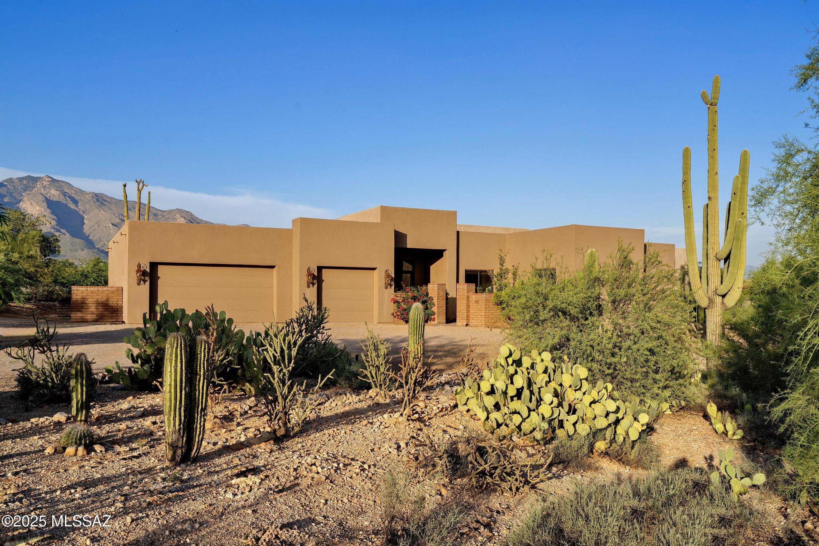 Set within the quiet and highly sought-after neighborhood of Shadow Hills, this thoughtfully designed residence embodies the essence of refined desert living. Every angle of the home has been considered to maximize the seamless indoor-outdoor connection, creating an environment that is as livable as it is visually striking. Upon entry, the home immediately reveals its intent: spaces that feel open and light, yet intimate and composed. Scored integral colored concrete floors lend a warm, textural foundation to the interiors, complementing soaring ceilings and expansive walls of glass that frame uninterrupted, large-scale mountain views of the Catalinas. Carefully curated interiors offer a balance of warmth and sophistication. Designed for both entertaining and everyday living, the layout encourages flow while providing distinct moments of quiet retreat.

At the heart of the home, the chef's kitchen is both stunning and functional, featuring a generous center island, bespoke cabinetry, stone surfaces, and top-end appliances. Adjacent, a butler's pantry provides additional prep and storage space, keeping entertaining effortless and the kitchen workflow seamless. Every detail has been considered, from materials to spatial design, creating an environment where form and function align perfectly.

The primary suite, privately situated, offers a restorative escape, framed by picture windows that invite soft, natural light and panoramic desert vistas. A serene, spa-inspired bath completes the retreat. Within the suite, a large walk-in closet provides generous storage, complemented by a second closet currently serving as a dedicated exercise room. Three additional ensuite guest bedrooms are thoughtfully positioned in the southeast wing of the residence, centered around a modern, multifunctional flex space, an inviting hub equally suited for a sleek media lounge, relaxed TV room, or vibrant communal gathering area.

Covered patios and private terraces extend seamlessly from the interior spaces, each oriented to maximize light, shade, and views throughout the day. The fully fenced backyard is a controlled, thoughtfully designed landscape, a curated composition of decomposed granite and synthetic turf, softened by lush vegetation on a fully automated irrigation system. Landscape lighting has been strategically integrated to highlight architectural lines, mature plantings, and pathways, creating an evening ambiance as compelling as the daytime views. Beyond the fencing, the property backs directly to untouched natural desert, preserving both privacy and a visual connection to the surrounding wilderness.

On the northwest side of the property, a dedicated sport court offers a versatile recreational amenity for everything from basketball to pickleball. An oversized three-car garage, recently treated with a fresh epoxy finish, provides durability, ease of cleaning, and a polished appearance.

Located minutes from Tucson's premier dining, shopping, and trail systems, yet offering a sense of being worlds away, this residence is a rare offering in one of the Foothills' most enduring communities, a home where architecture, setting, and lifestyle exist in perfect balance.