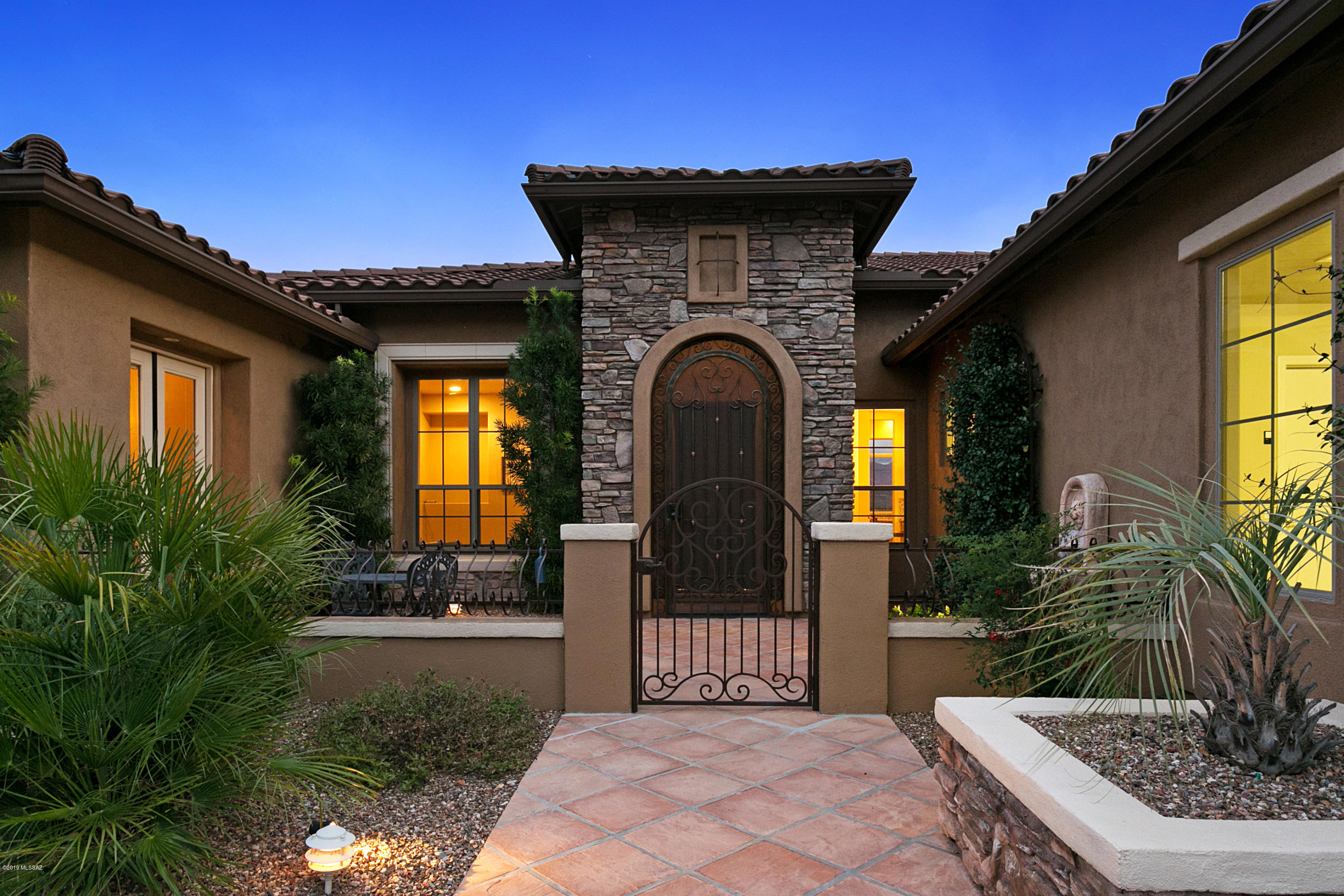 Enjoy top-of-the world panoramic mountain and city light views from this rarely available & professionally decorated Catalina model in The Preserve at SaddleBrooke. This beautifully appointed home & pool/spa enhanced backyard were featured in both the Oro Valley & Tucson Lifestyle Magazines.  Features include 16'' limestone tile gas fireplace & stacked stone wall in family room, designer light fixtures, outdoor  BBQ/Bar area, heated pool & spa with water feature & separate guest quarters with beverage frig & full bath. The chefs kitchen has stonite countertops, professional grade stainless steel appliances including double convection ovens, gas range, built-in refrigerator, & 42'' uppers. Principal rooms have large picture windows that provide breathtaking views of the Catalina Mountains.
