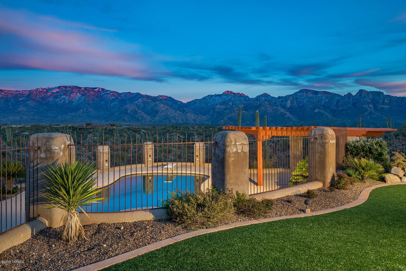 Quintessential, Custom Arizona Hacienda on 1.4 acres w/ panoramic mountain views in prestigious, gated Honey Bee Canyon Estates. Charming front flagstone courtyard w/ fountain, exquisite living and dining rm w/ soaring ceilings, hand hewn wood beams throughout, and 5 FP. Gourmet island kitchen w/ granite counters, 2 sub zero refrigerators, 2 dacor ovens, 6-burner gas range. 18-22 inch mud adobe walls. Resort styled backyard w/ covered patio, pool, spa, FP, built in BBQ and kitchen area under ramada, over looks the majestic views and preserved Honeybee landscape. Rec/Media/Den w/ fridge. 3 car garage w/ custom built ins. Designed for the most discriminating buyer. Owner is open to seller financing.