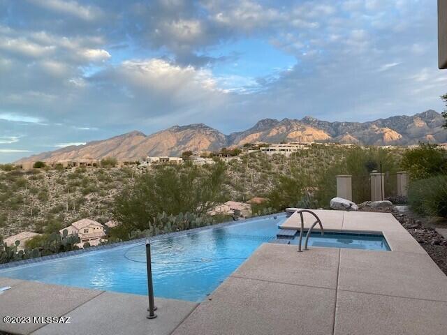 Impeccable taste & style await you. Custom one story home in luxurious gated Foothills Sabino Mountain community.  Single story split plan 4 bed w/ 4.5 baths, 2 Master Suites:  Breathtaking mountain, city & panoramic views.  Premium finishes throughout. Foyer leads to living & dining areas w/ floor to ceiling windows taking advantage of every view.  Kitchen has premium finishes w/ Clear Alder cabinetry, granite counters, double sink, high end stainless appliances w/ 48'' refrigerator, cooktop, double ovens, dishwasher, warming drawer, prep sink, lg island & built in desk area. Open Family room off kitchen w/ access to outdoor kitchen & backyard.  All ANDERSON doors & MILGARD windows: Powder rm w/ vessel sink & granite counters.  Oversized Master Suite boasts Lg sitting area.