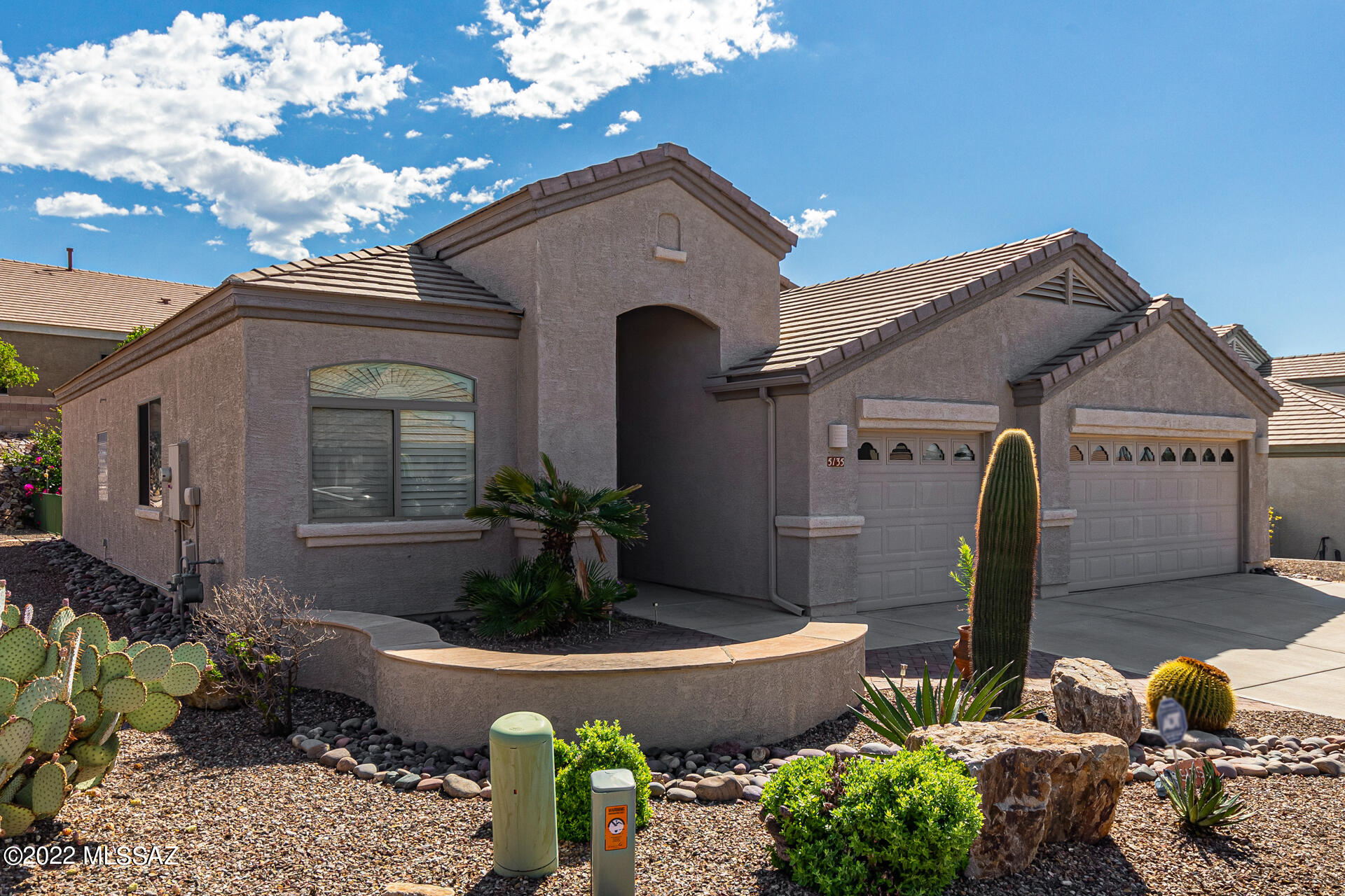 Fantastic corner lot property showcasing a spacious 3-car garage in The Highlands at Dove Mountain! Gated 55+ community. Come inside to discover perfectly-sized living & dining areas offering soothing palette, plantation shutters, neutral tile floor, & carpet in all the right places. The immaculate kitchen boasts plenty of wood cabinets w/see-through cupboards & crown moulding, SS appliances, a pantry, recessed lighting, granite counters, stylish tile backsplash, & peninsula w/ breakfast bar. Have a good night's sleep in the main bedroom featuring a private bathroom with dual sinks, walk-in tub, & a walk-in closet. Enjoy mesmerizing mountain views from the lovely backyard with covered patio, built-in BBQ, & easy-care landscape.